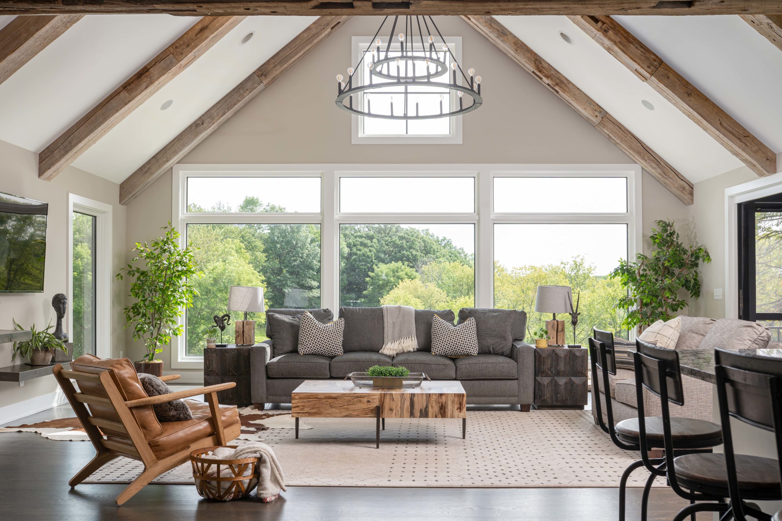 A living room with large windows and wood beams in our Kitchens portfolio.