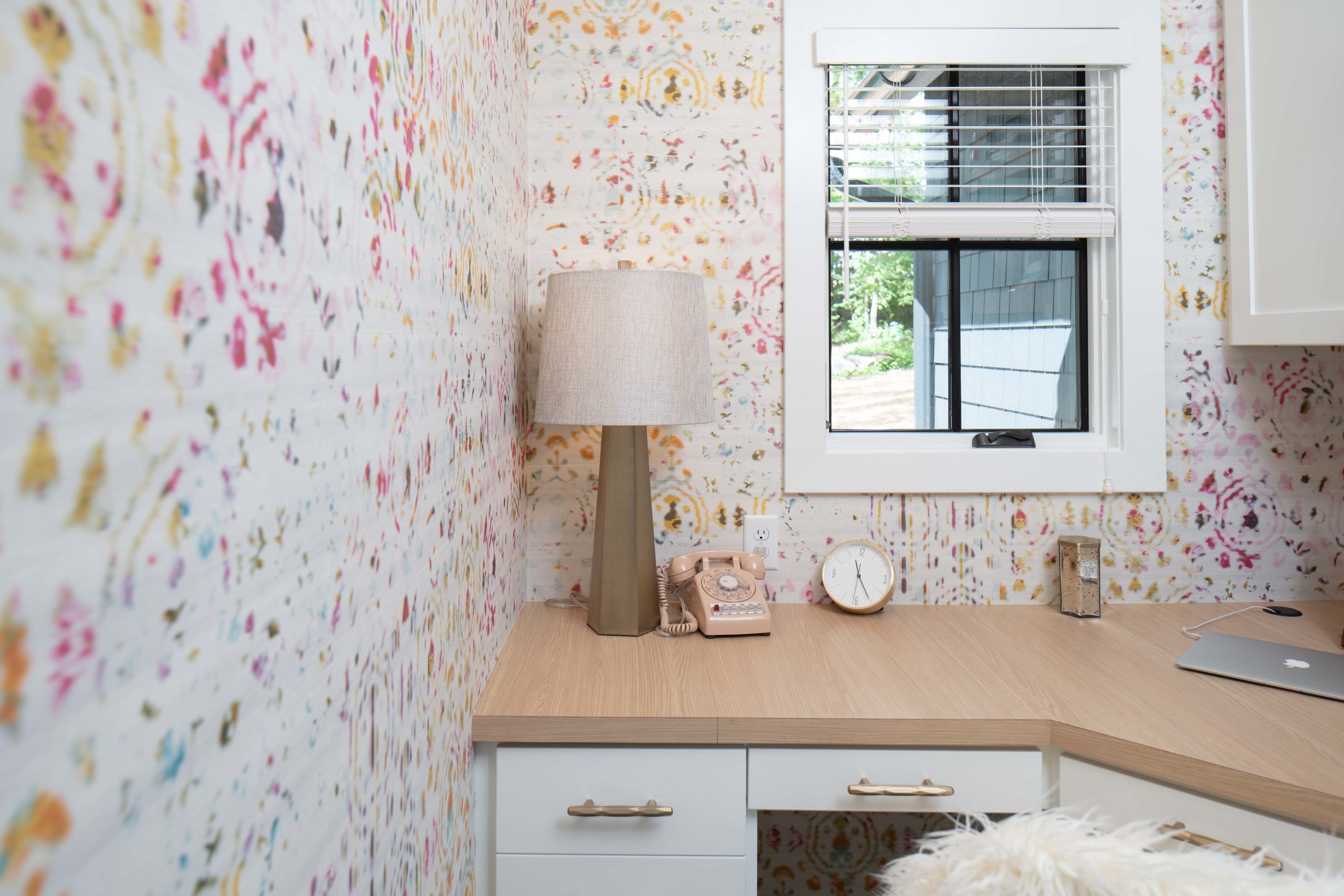 A home office with floral wallpaper and a desk, perfect for those looking for design inspiration in their kitchens portfolio.