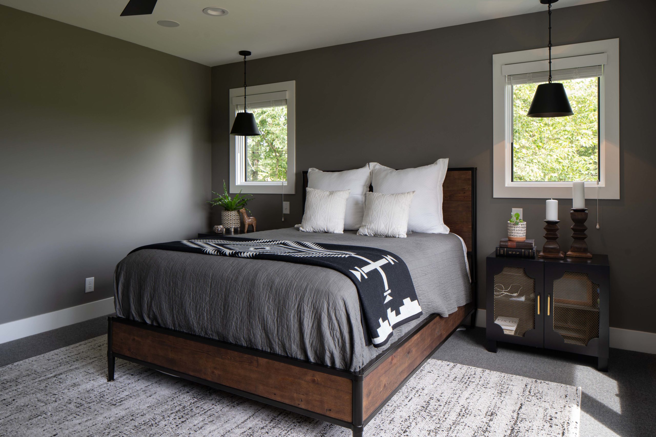 A bedroom with gray walls and a bed from the portfolio.