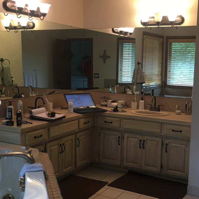 A bathroom featuring two sinks and a tub.