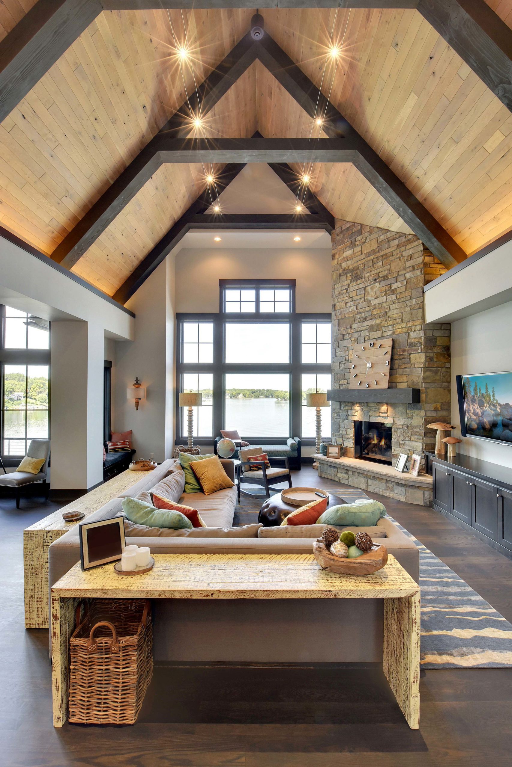 A large living room with wood beams and a fireplace, perfect for cozy gatherings and relaxation.
