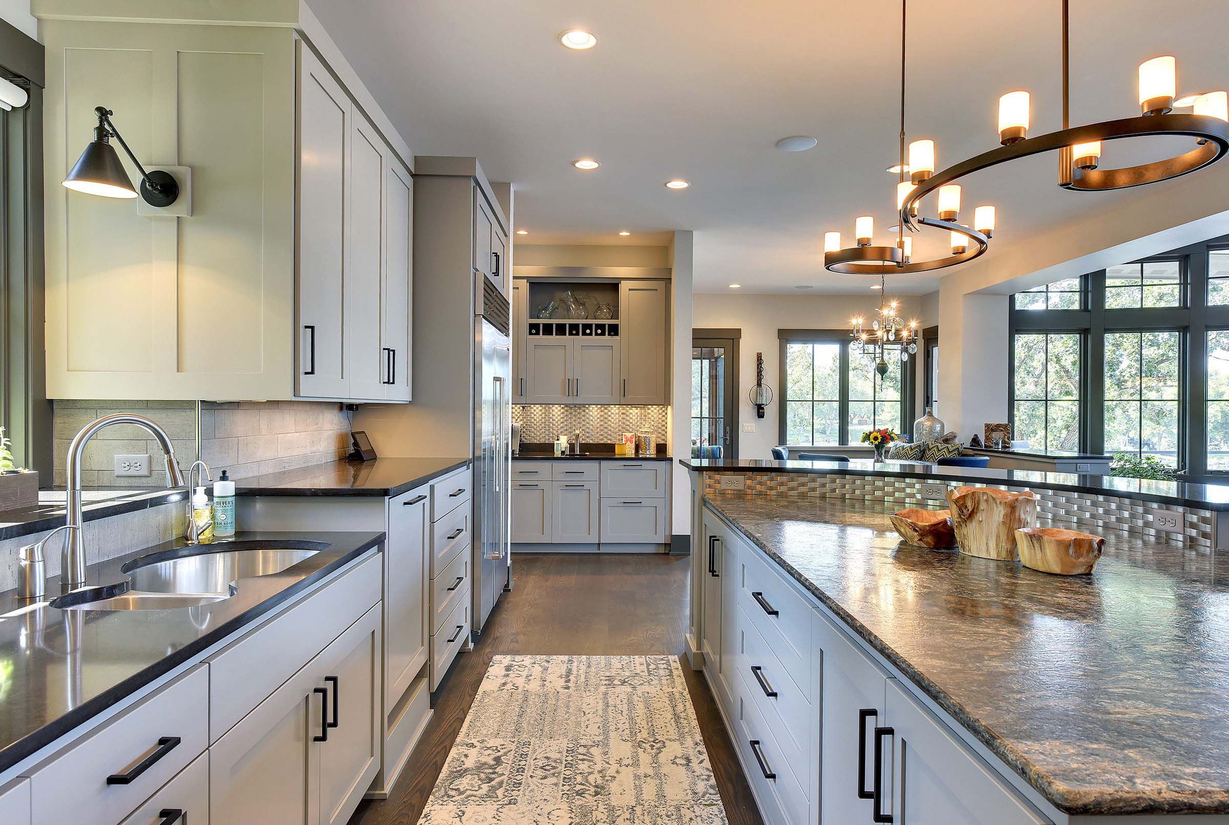 Kitchens in portfolio showcasing granite counter tops and stainless steel appliances.