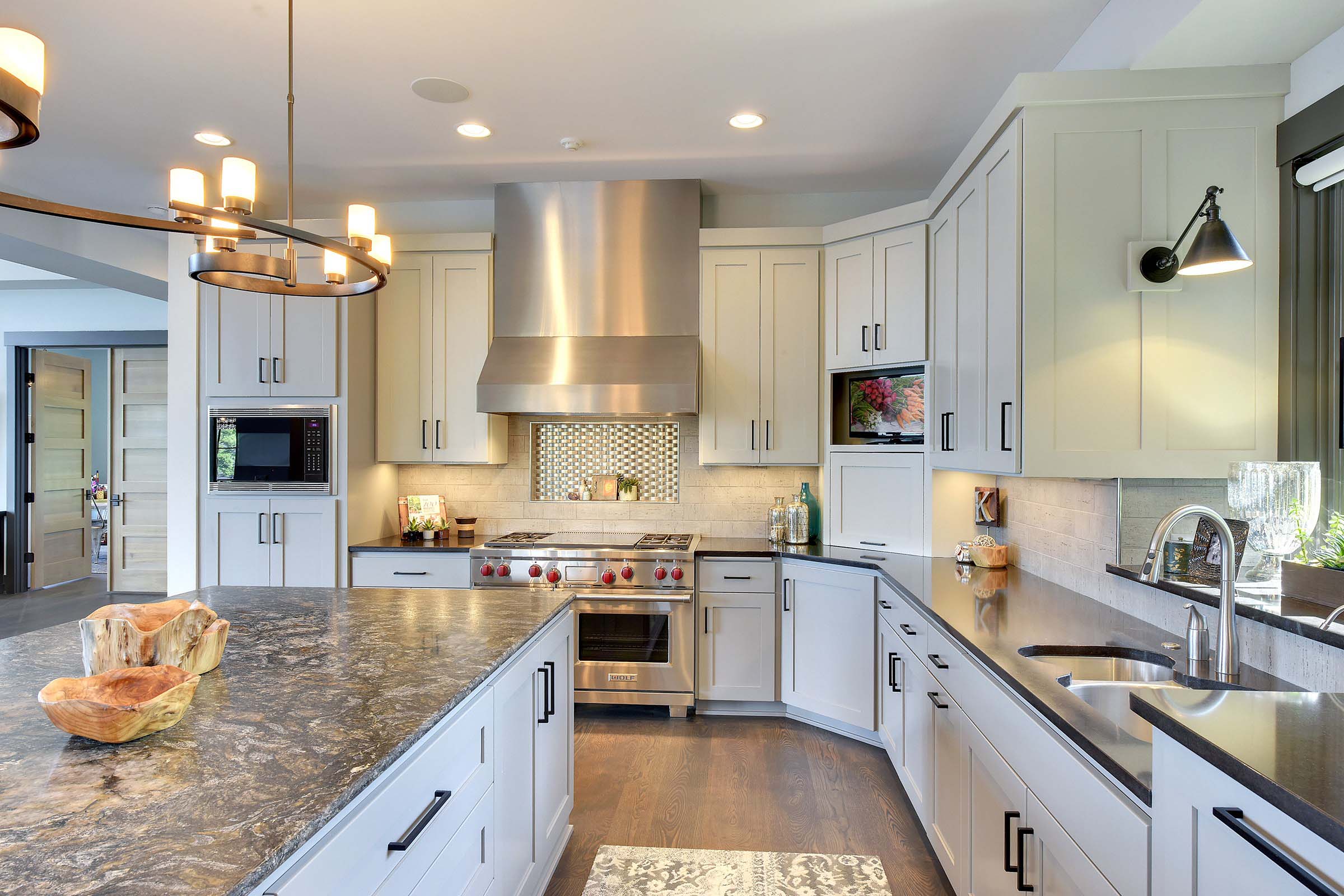 Kitchens portfolio showcasing a stunning kitchen with white cabinets and granite counter tops.