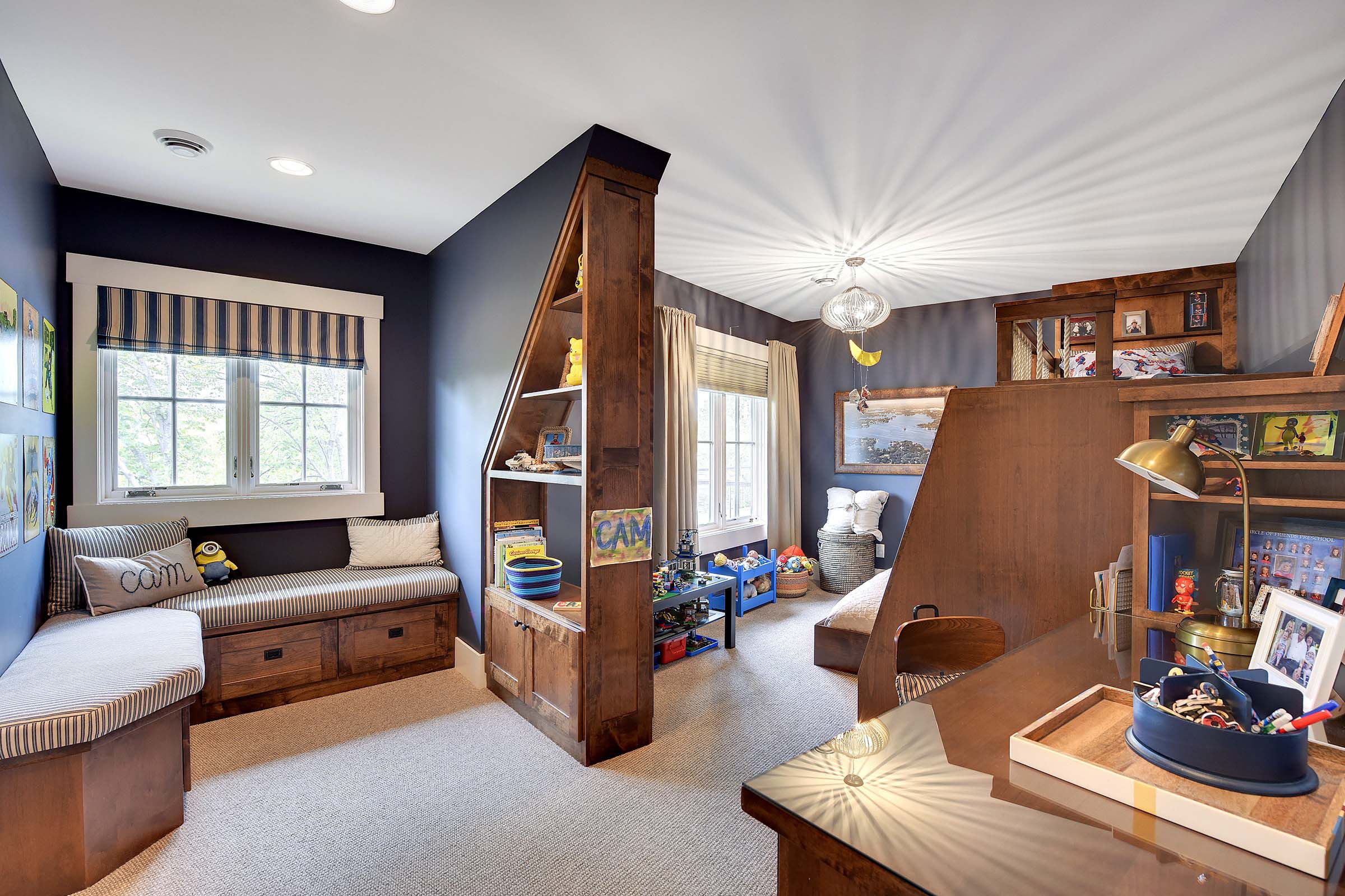 A boy's room with a bed and a desk, showcased in our portfolio.