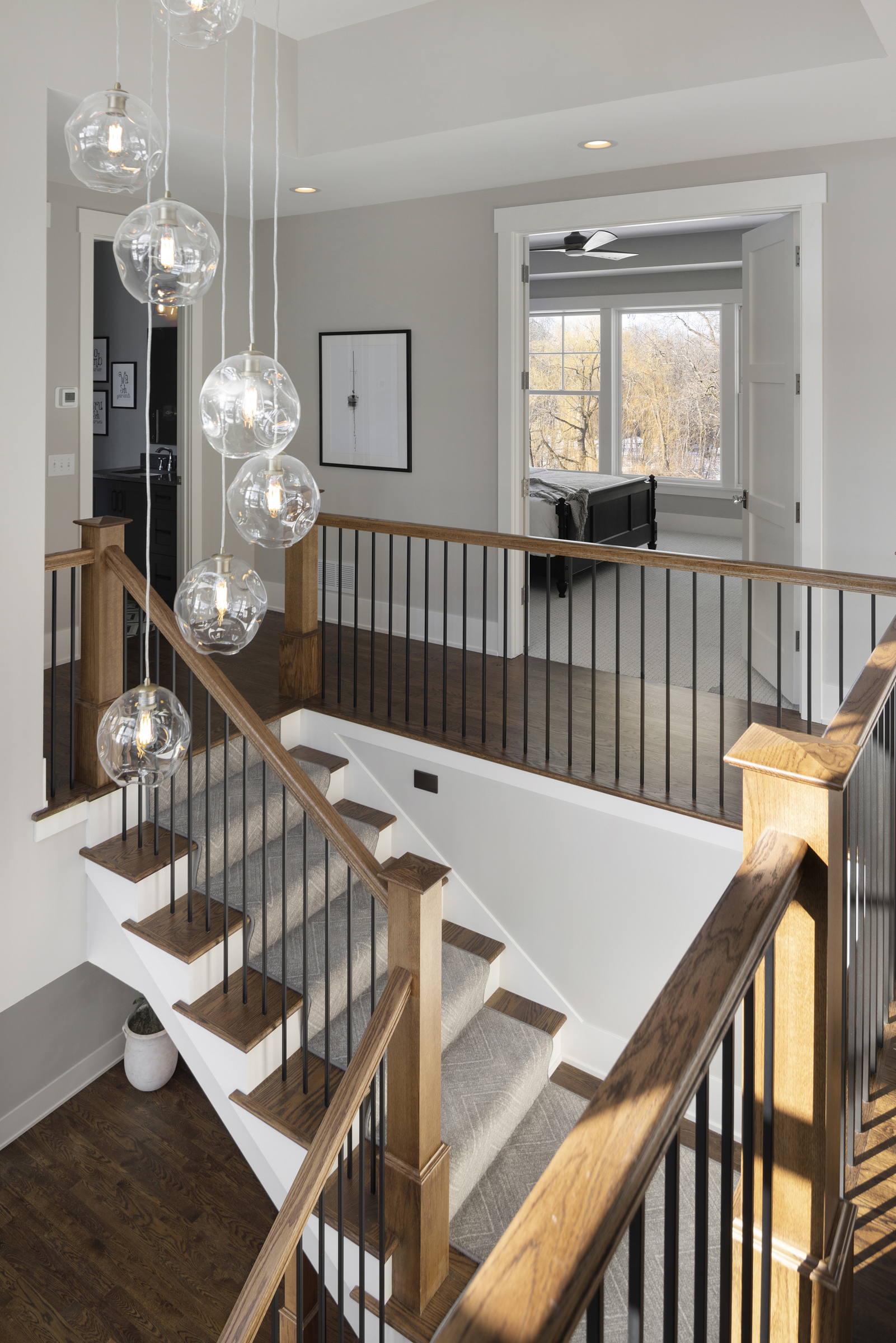 Staircase with wood railing posts and metal rails
