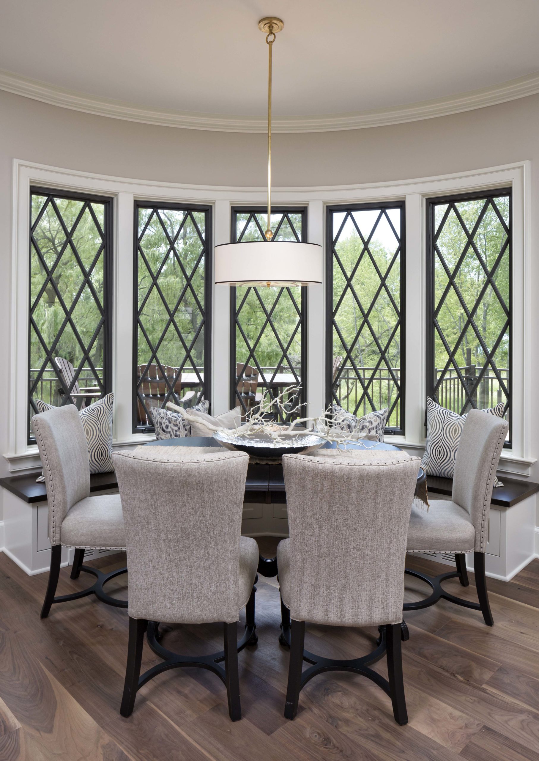 grey fabric chairs around a black dining table