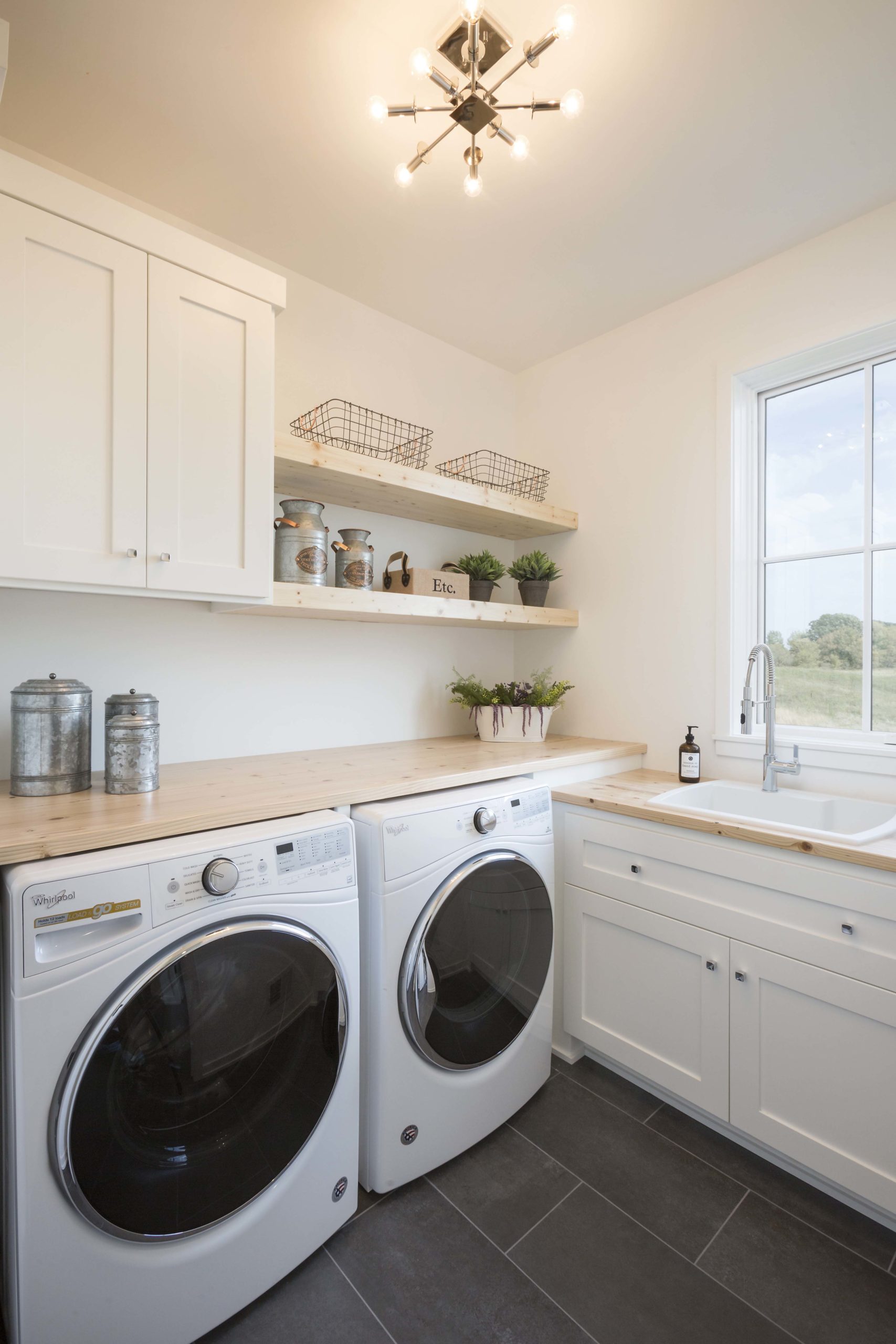 A Reverence farmhouse in Lakeville, Minnesota with a laundry room equipped with a washer and dryer.