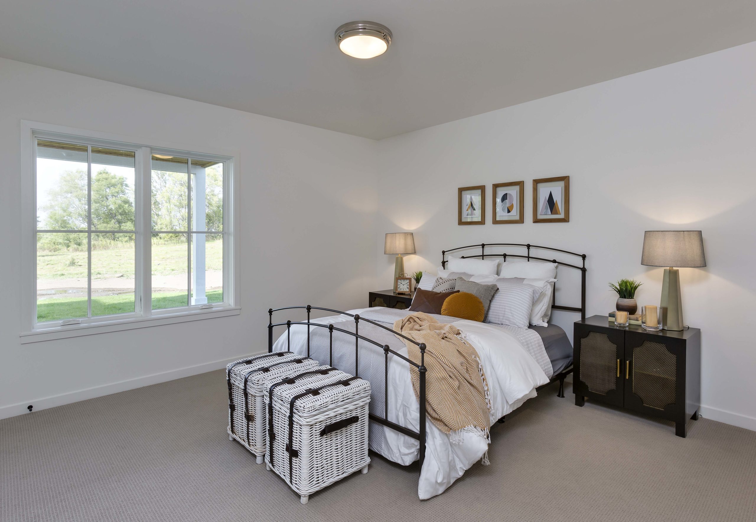 A Reverence farmhouse bedroom in Lakeville, Minnesota with a bed and a dresser.