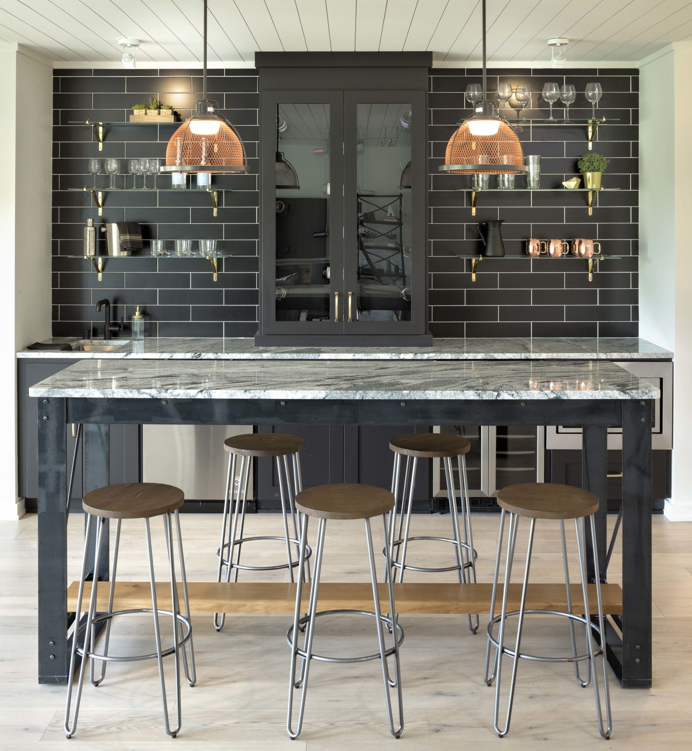 A Reverence kitchen with a farmhouse-style bar and stools in Lakeville, Minnesota.