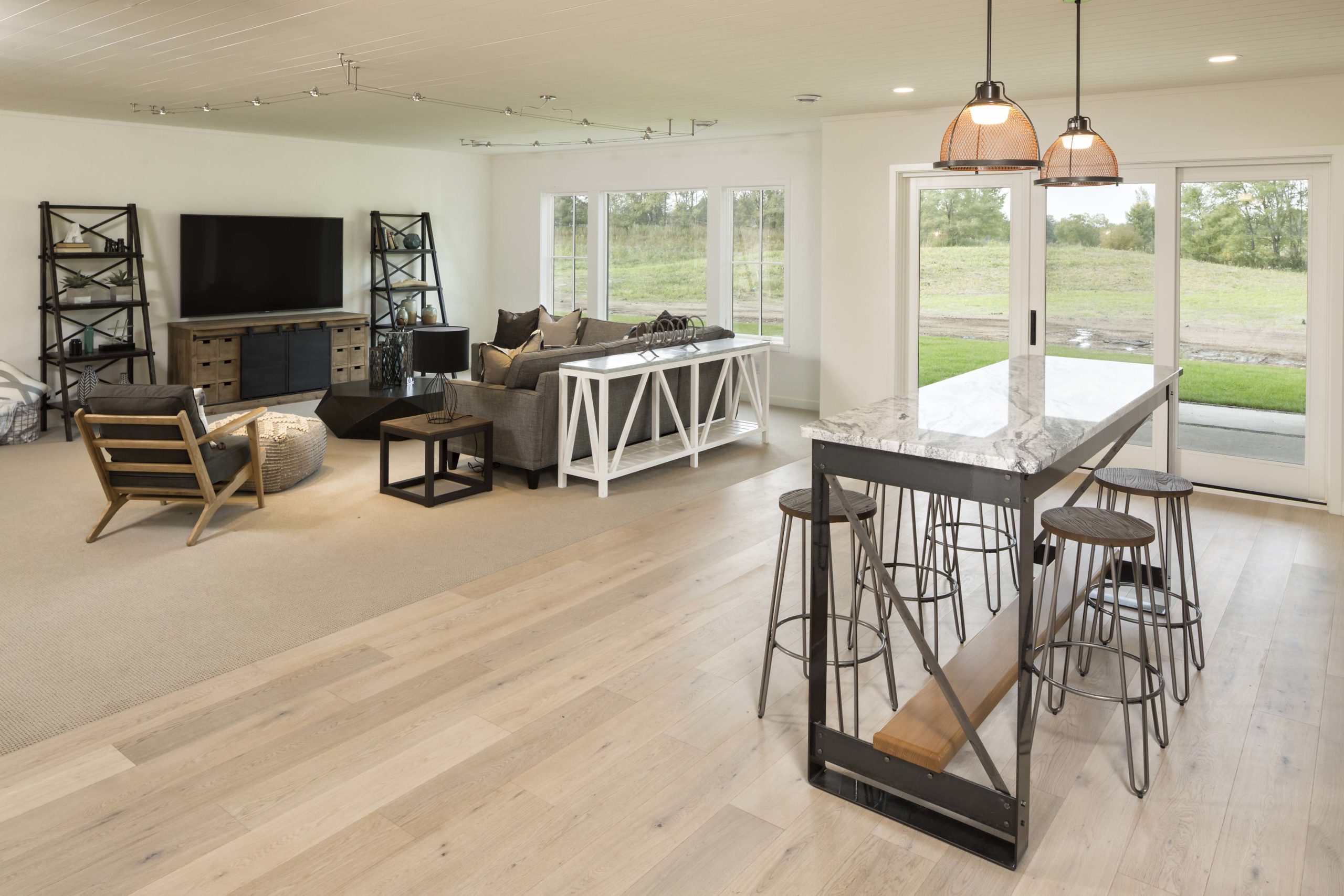 farmhouse style basement with oak wood floors and black and white furniture