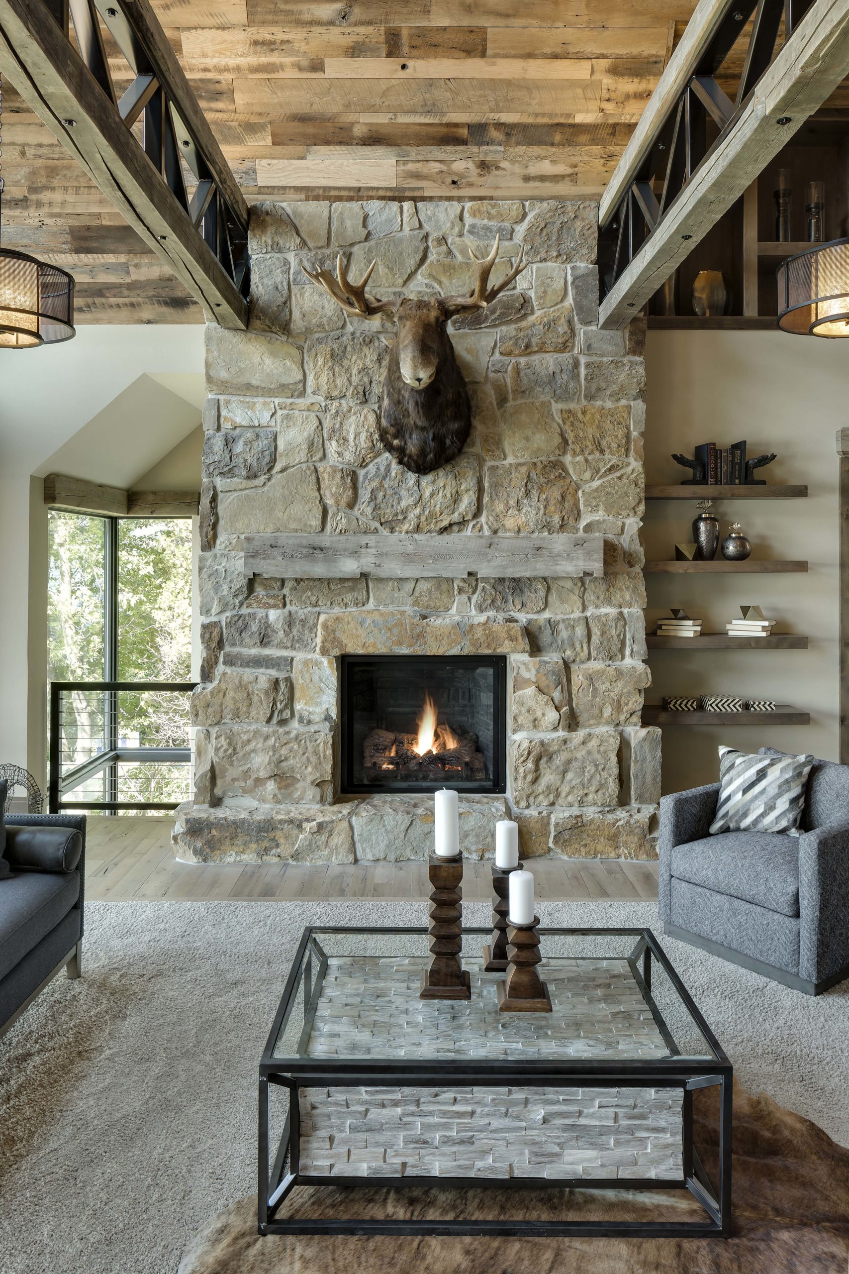 stone fireplace with moose head hanging above