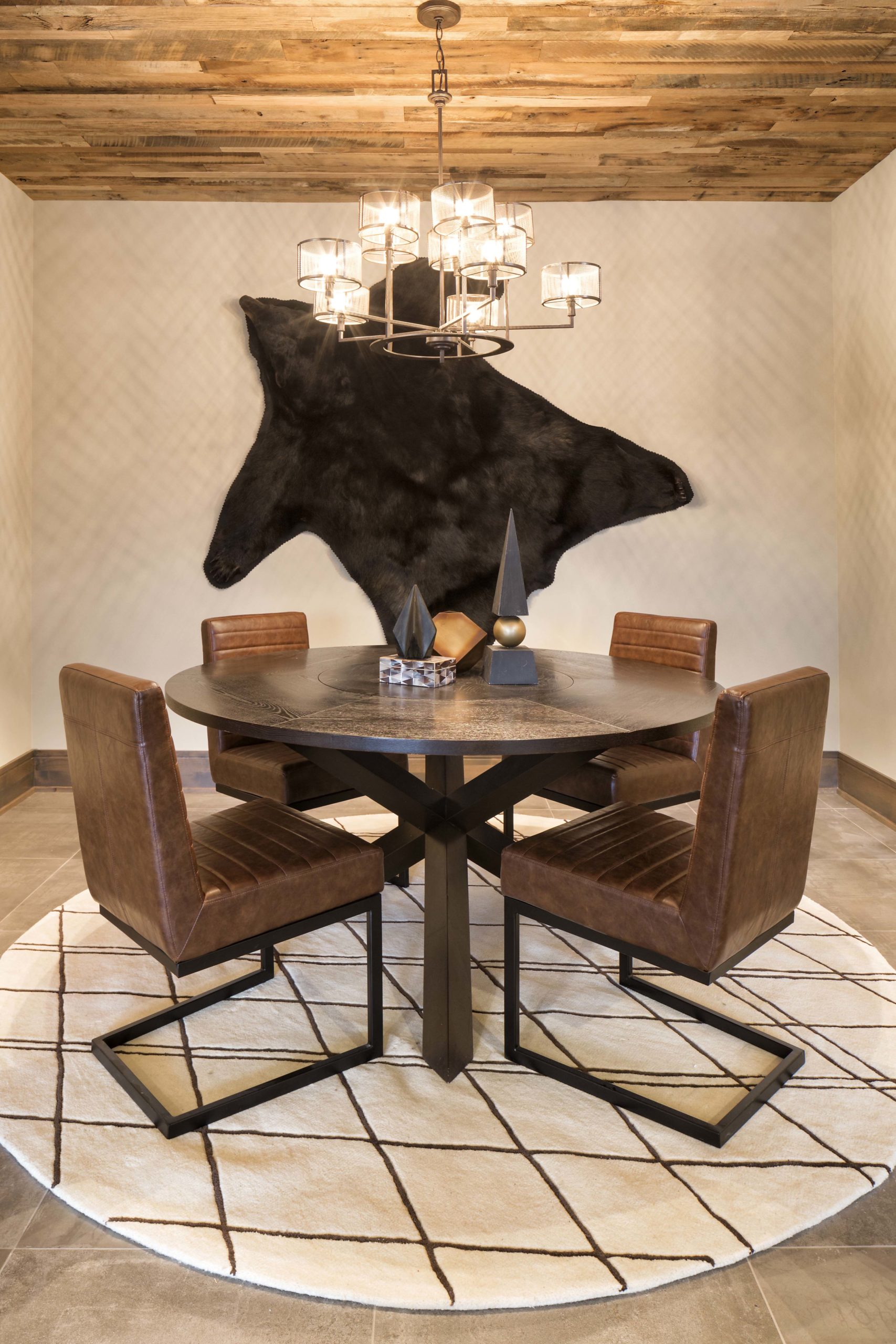round table with four chairs and bear skin hanging on the wall