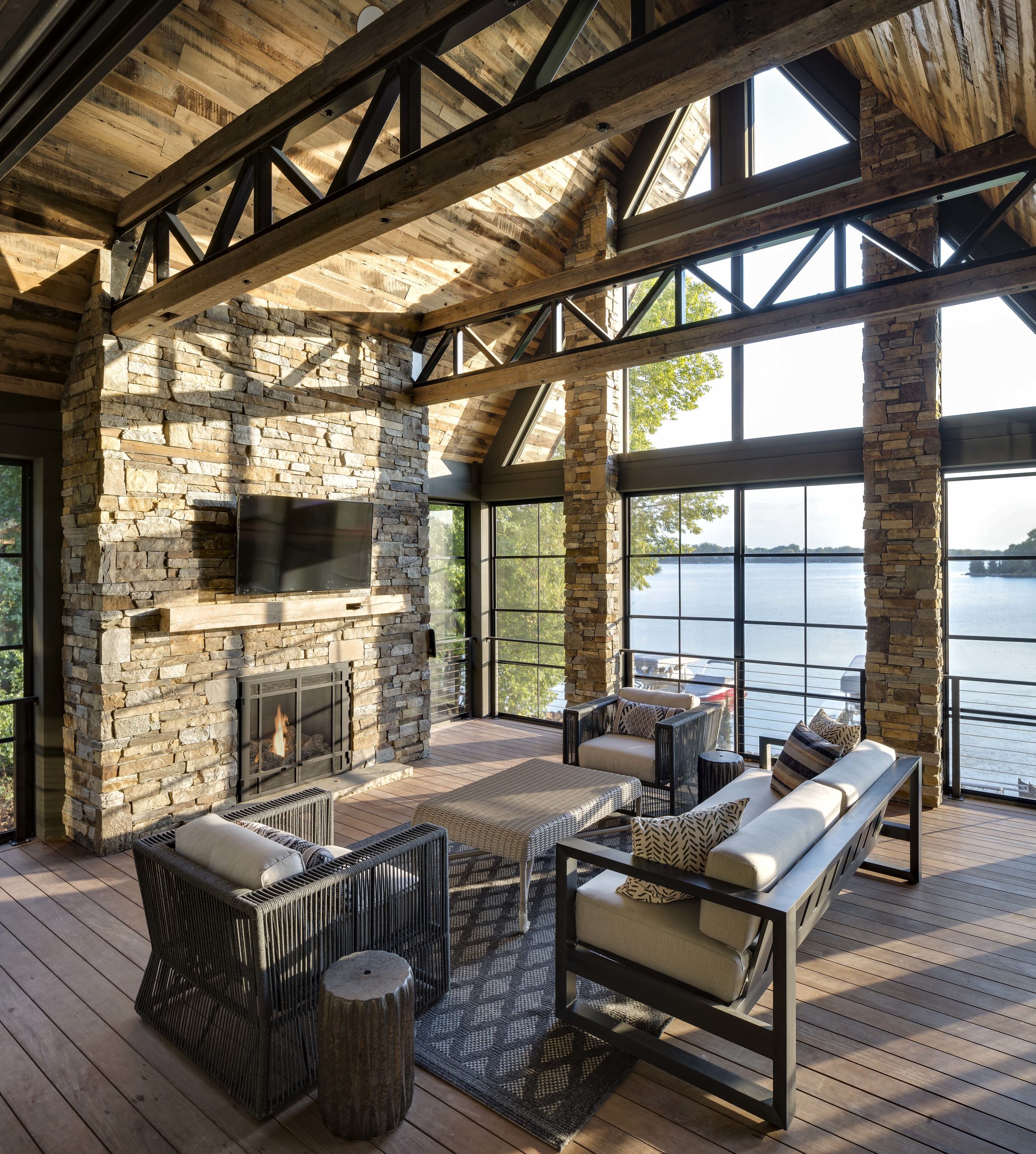 rustic stone living room with floor to ceiling windows