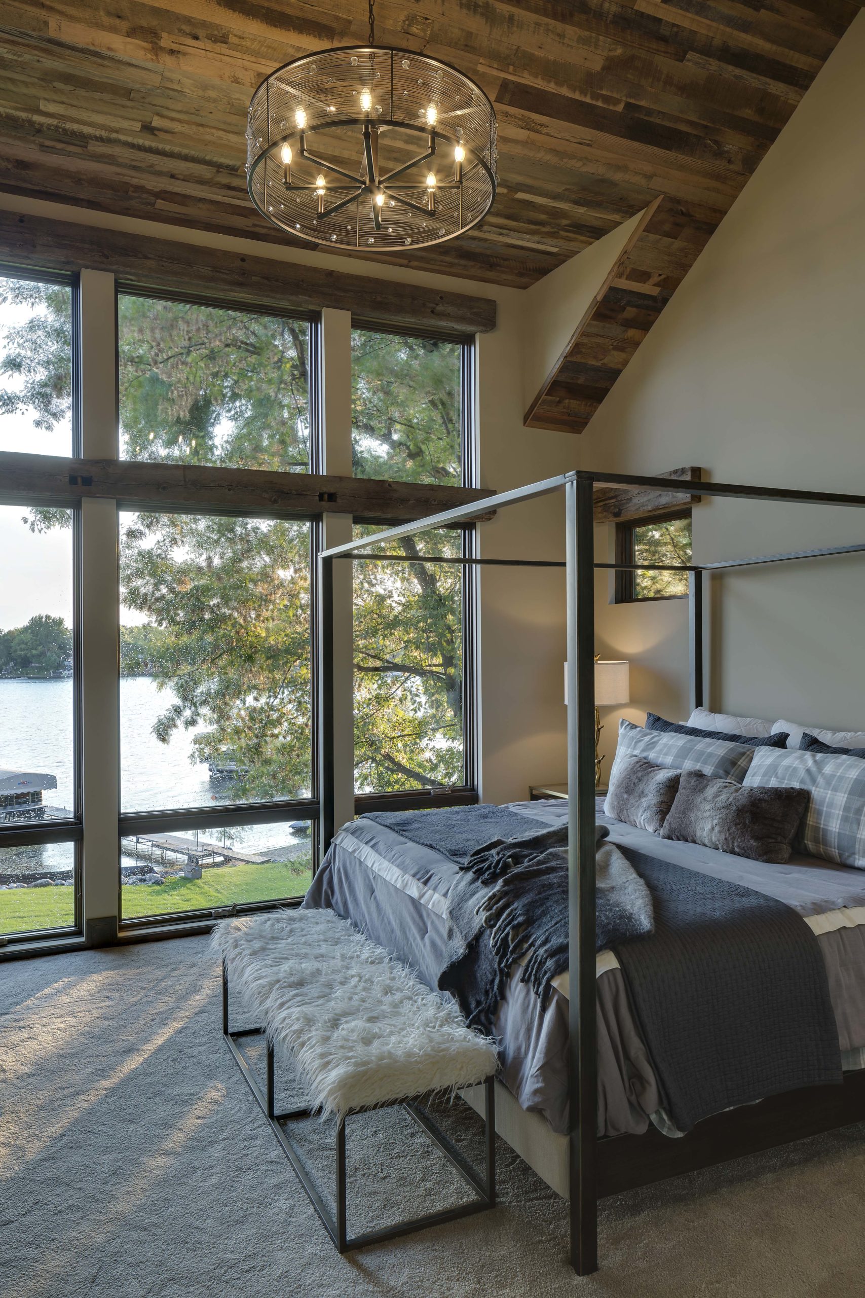 master bedroom with canopy bed and view of the lake out the window