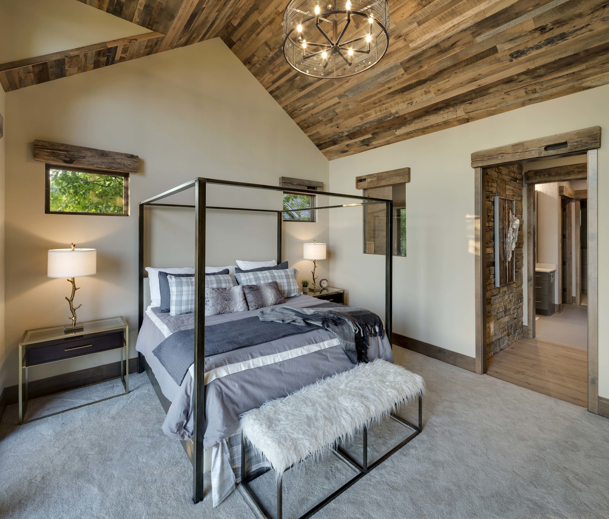 Master bedroom with canopy bed and reclaimed wood ceiling