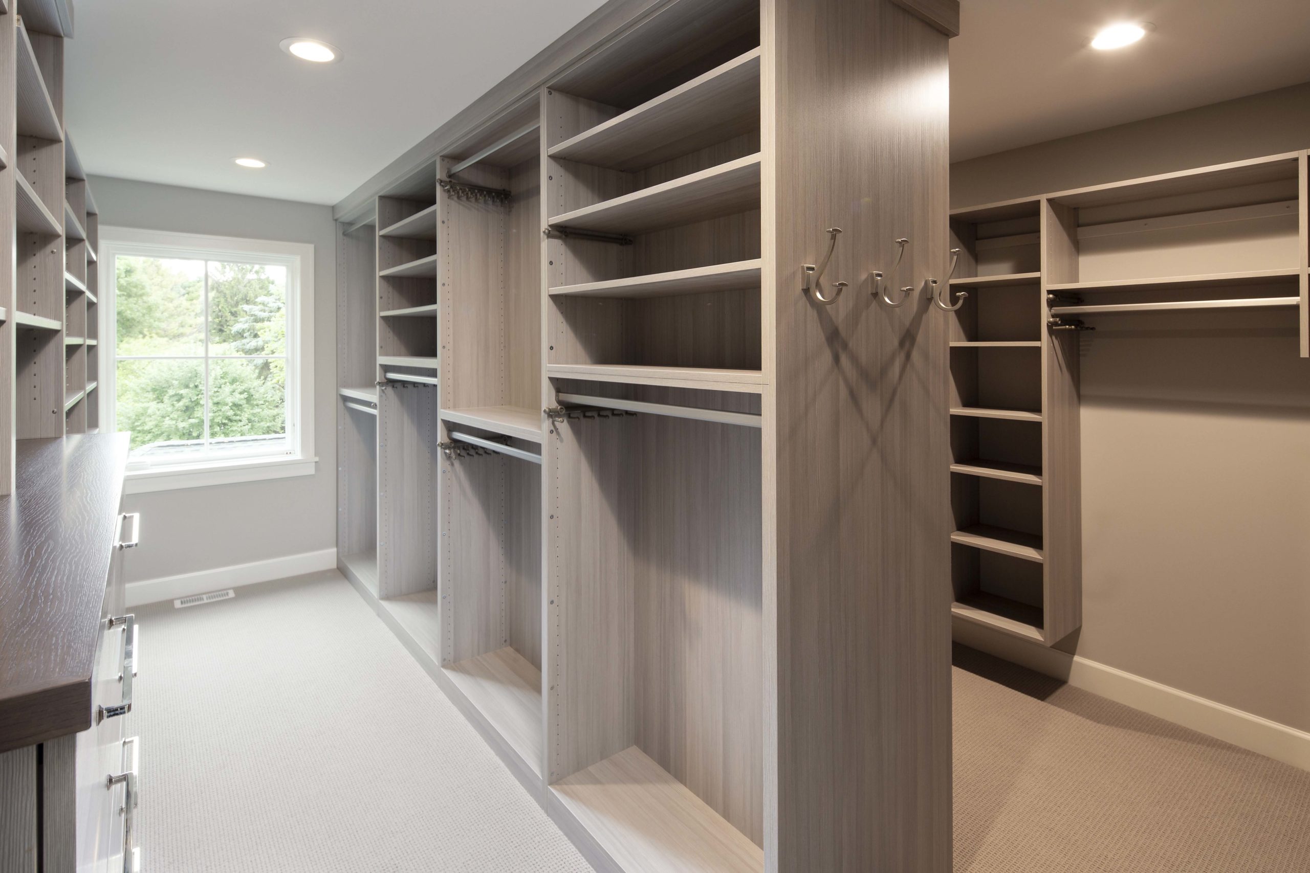 master closet with built in shelving and storage