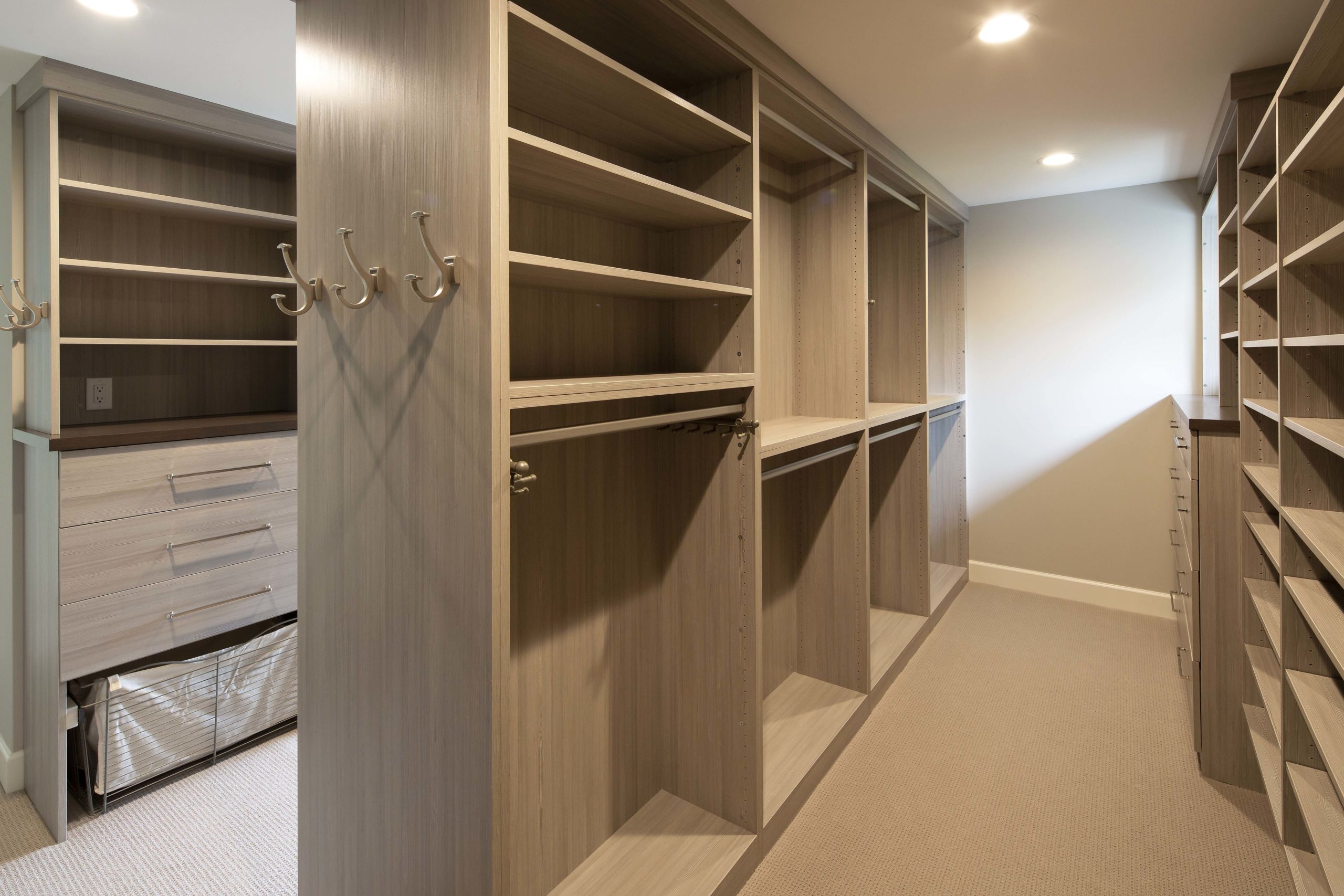 master closet with built in shelving and storage