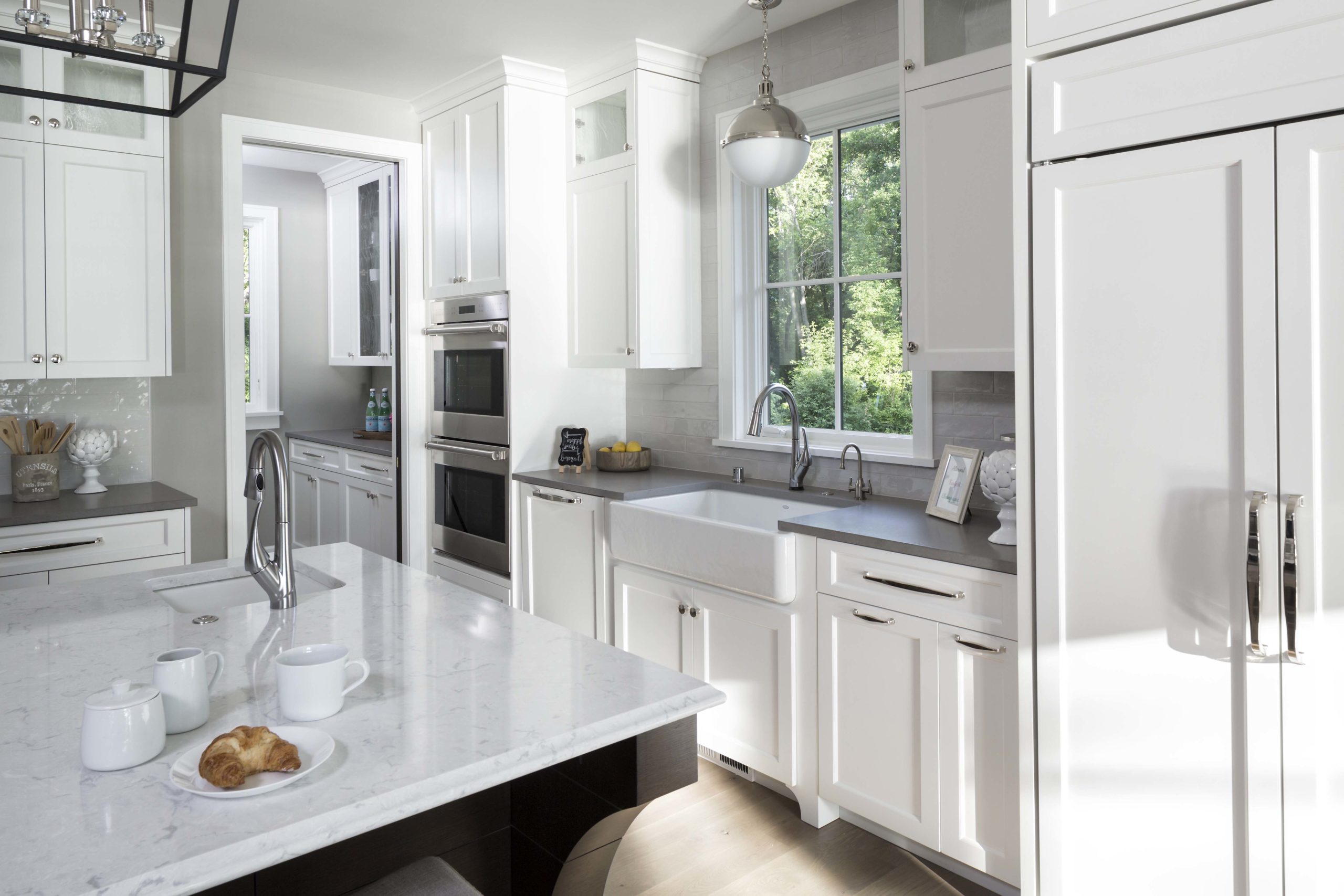 white kitchen with white fridge, white cabinets, and white countertops