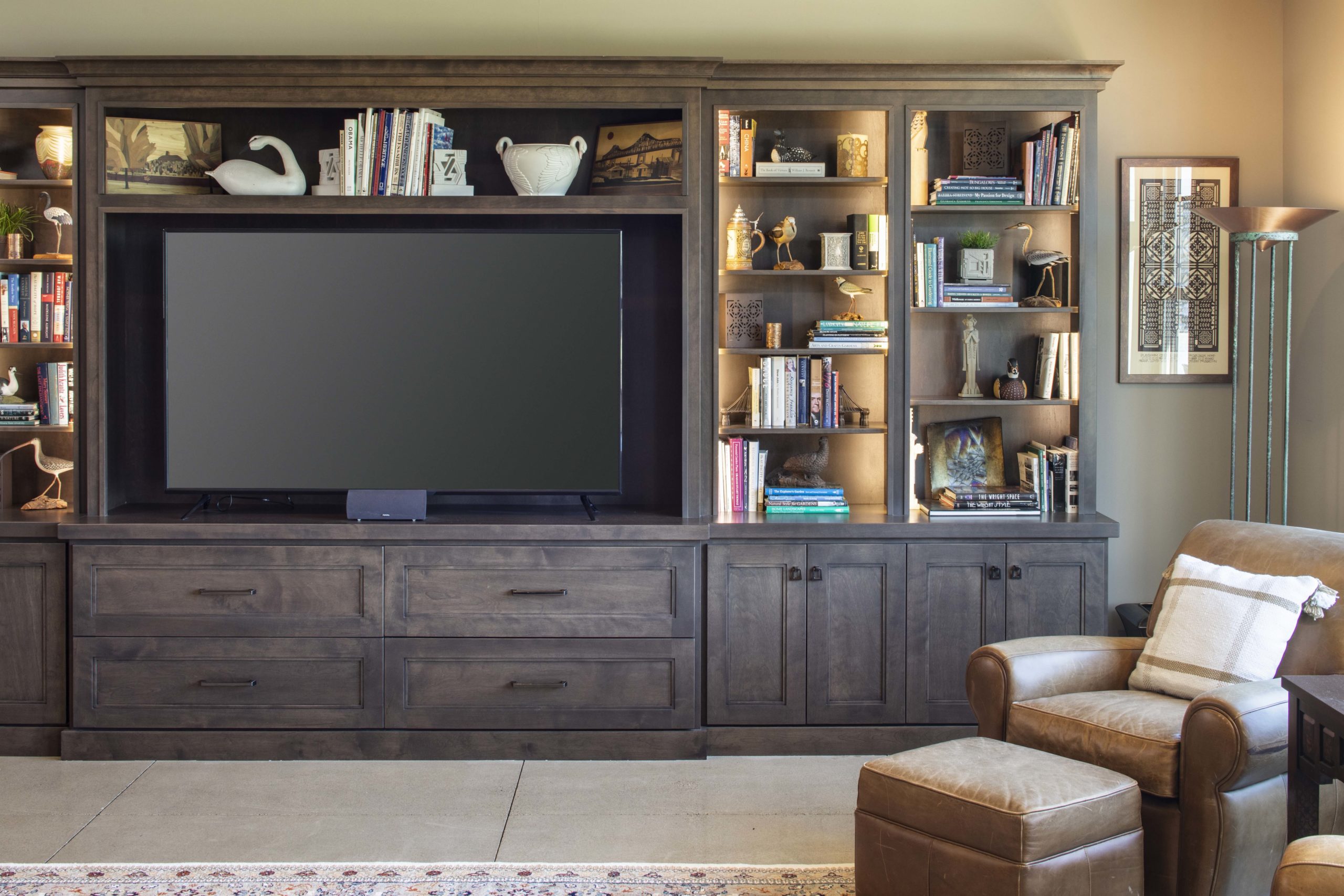 living room television with dark brown built in shelving