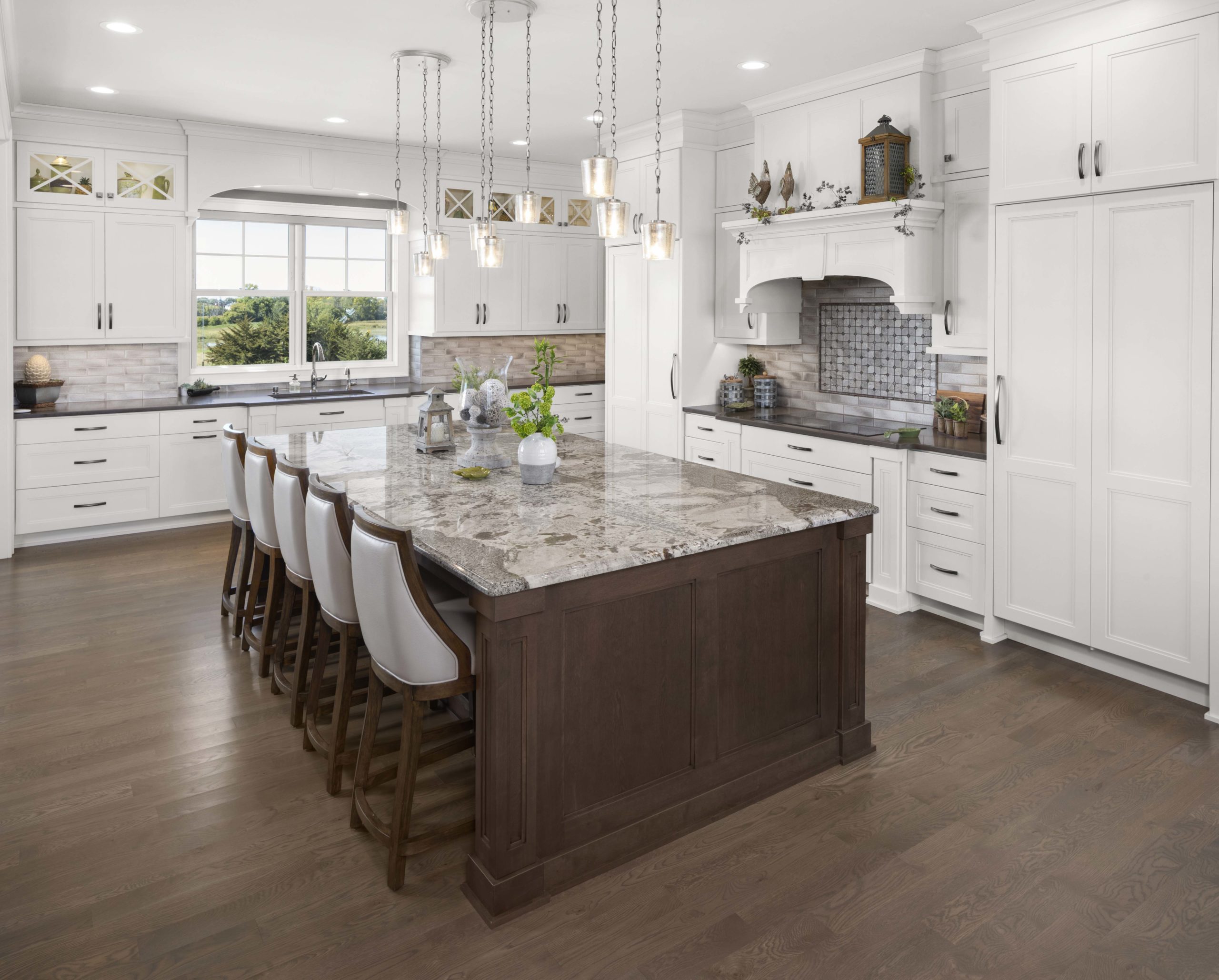 white kitchen with a brown island and granite countertops