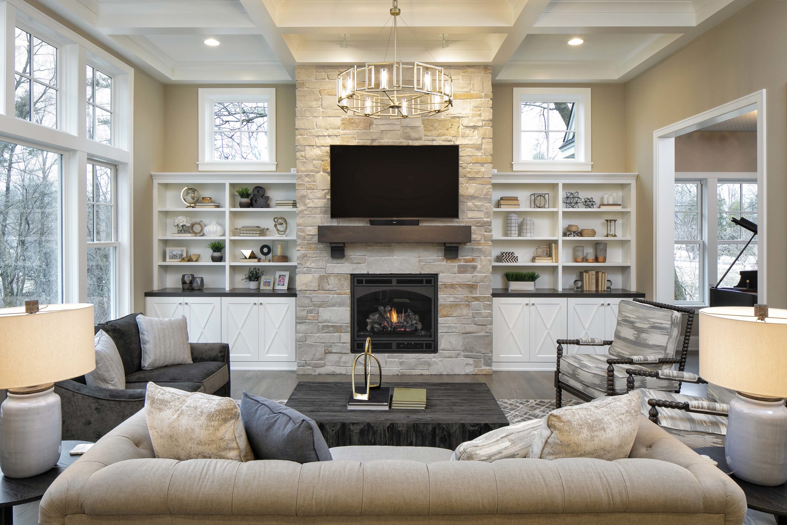 living room with built ins on both sides of a large fireplace