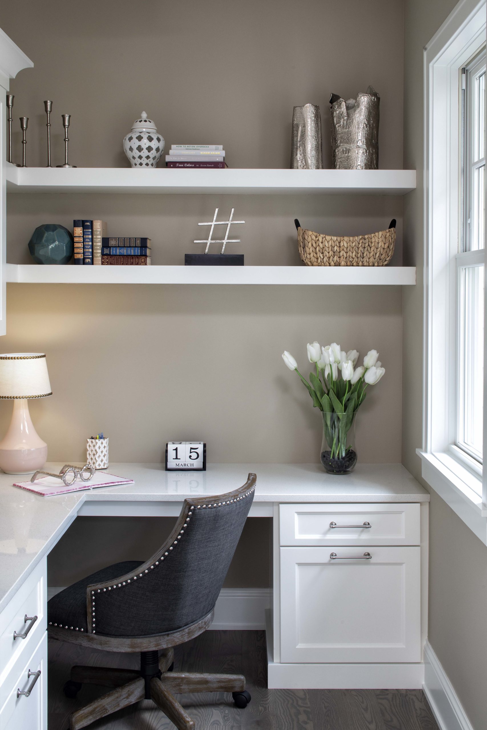 home office desk with white shelving around it