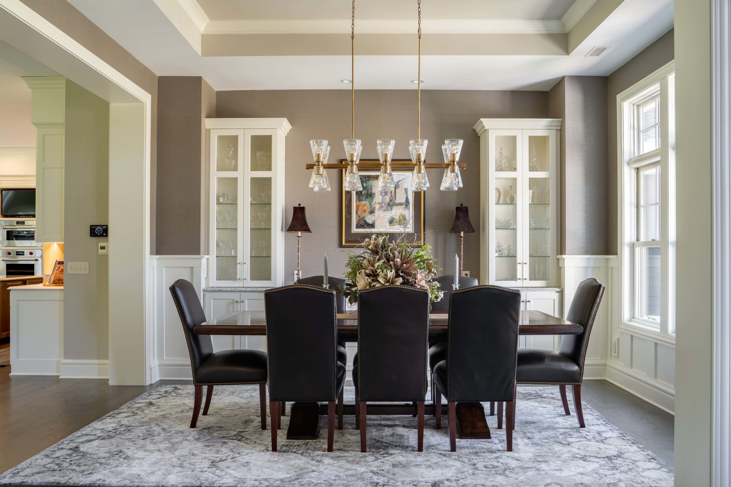 A dining room with black chairs and a chandelier on White Oak Lane.