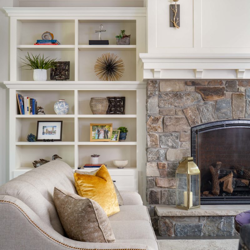 A cozy living room on White Oak Lane, complete with a fireplace and bookshelves.