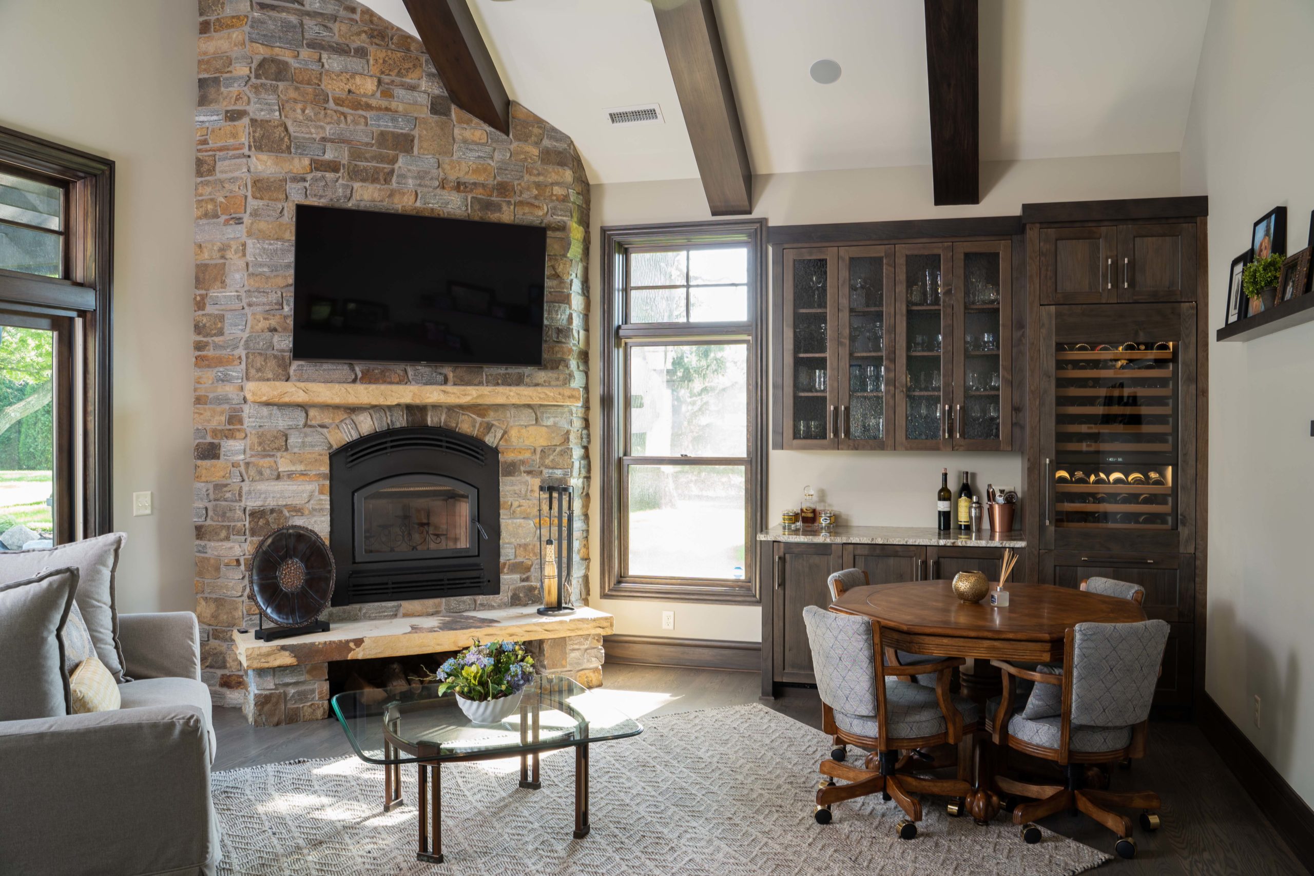A cozy living room on White Oak Lane with a stone fireplace and tv.