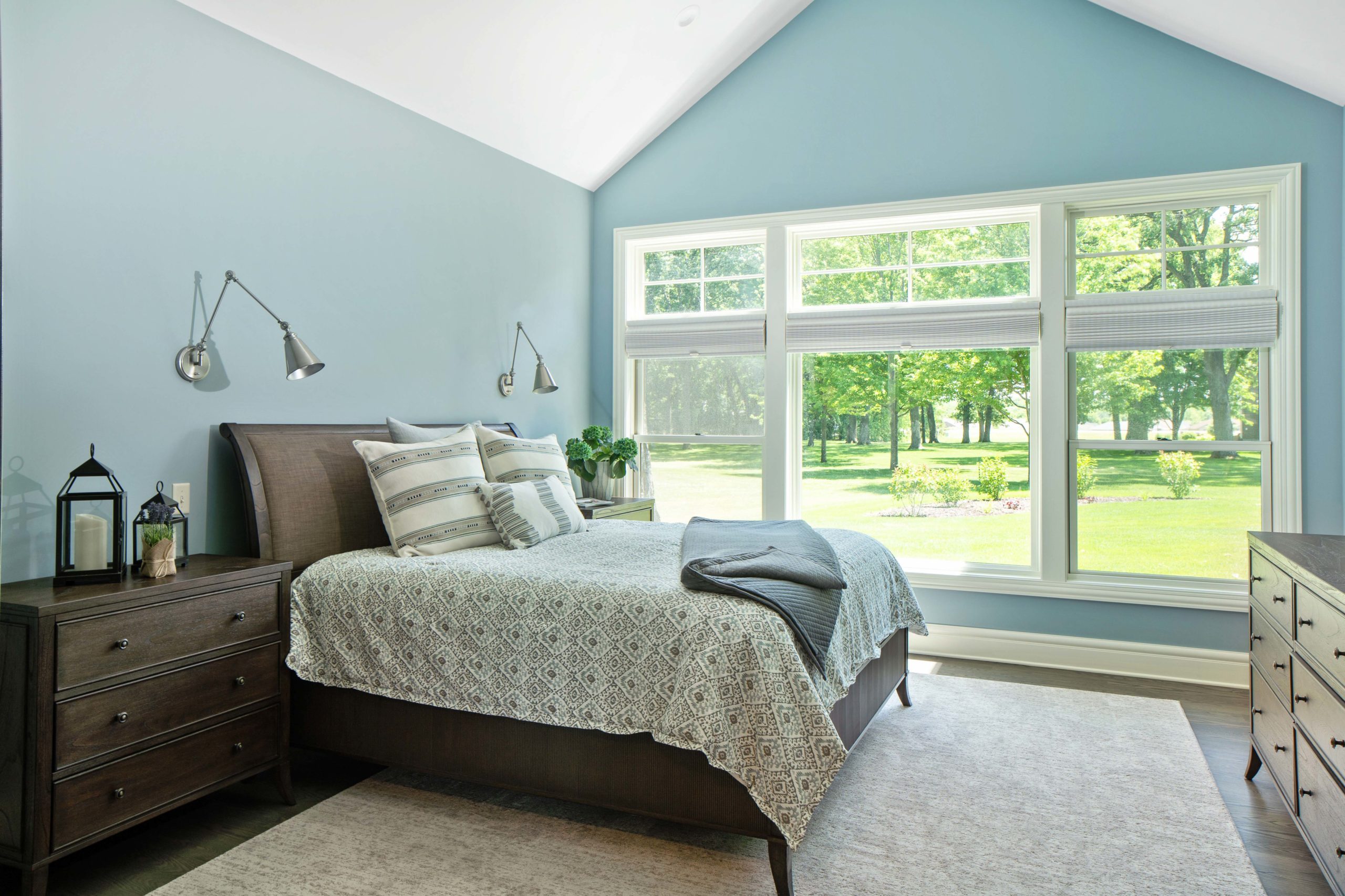 A bedroom on White Oak Lane with blue walls and a bed.