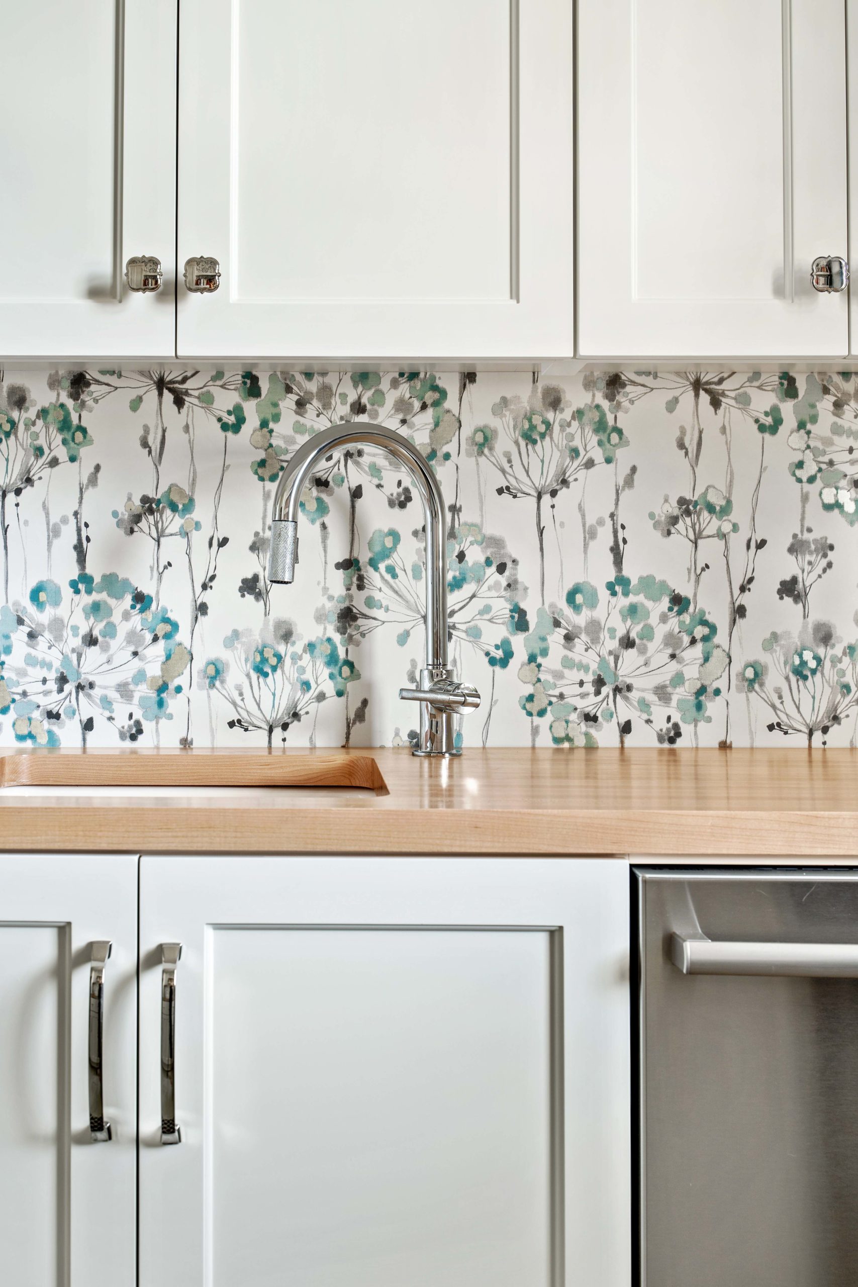 A White Oak Lane kitchen with a floral backsplash.