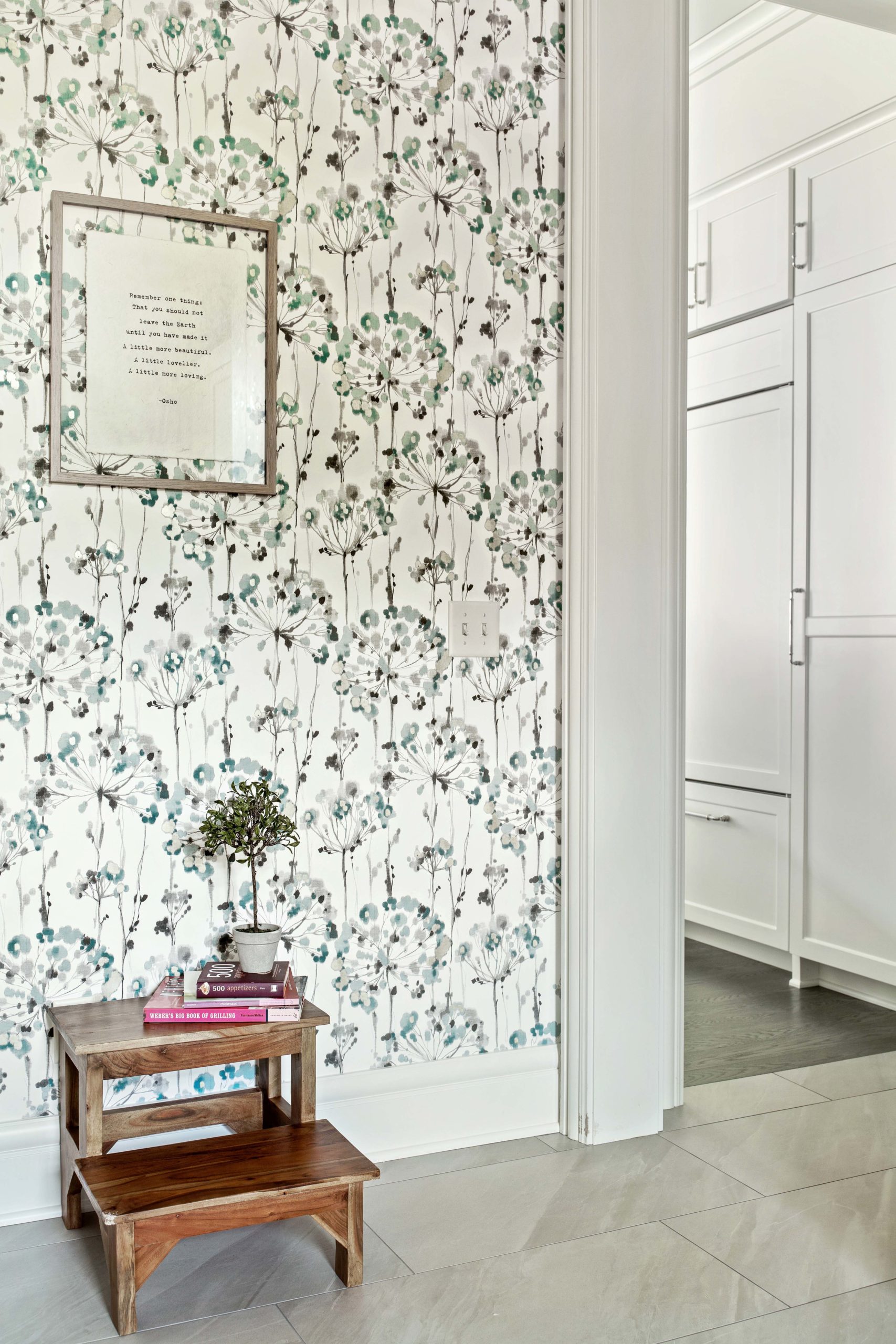 A White Oak Lane hallway adorned with a white and green floral wallpaper.