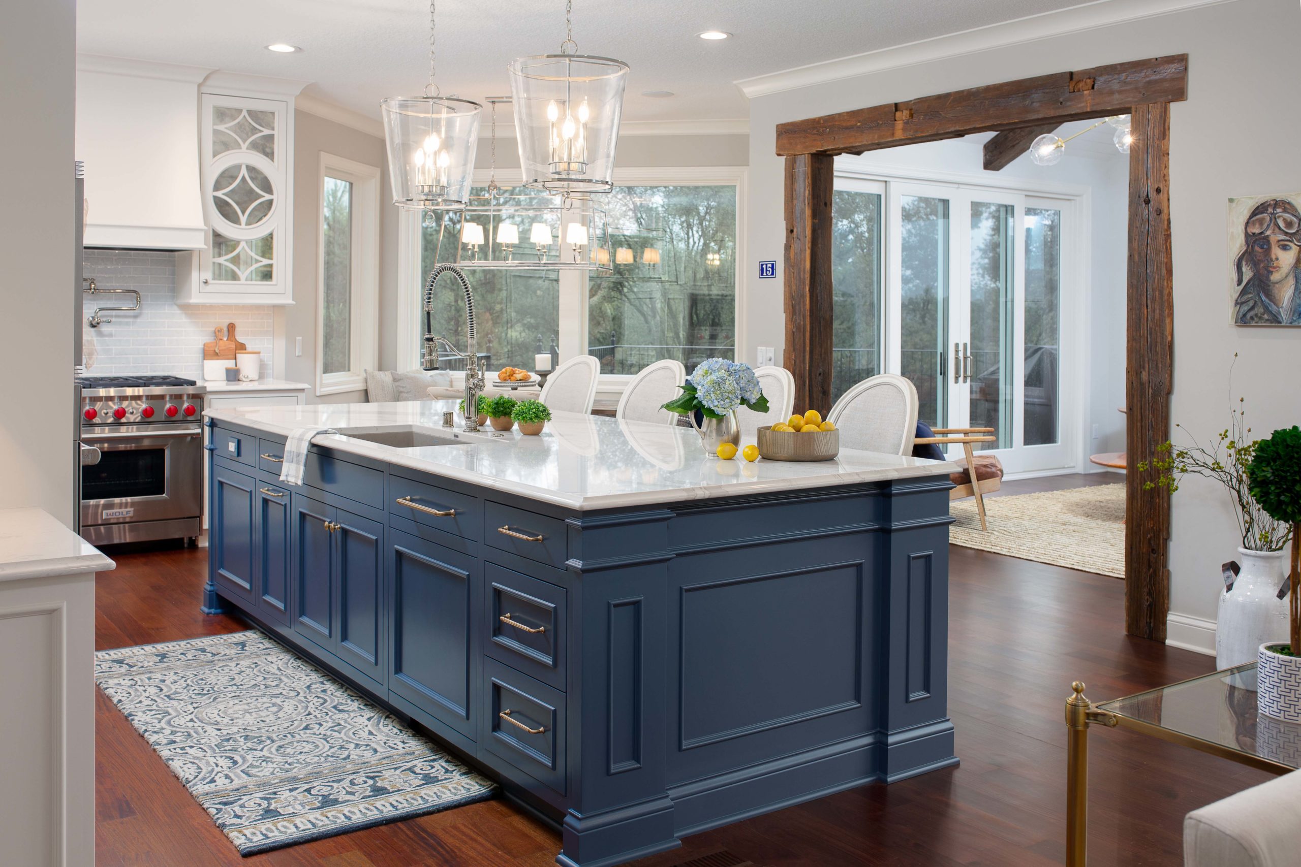 French country style kitchen with oversized island painted blue and white countertops