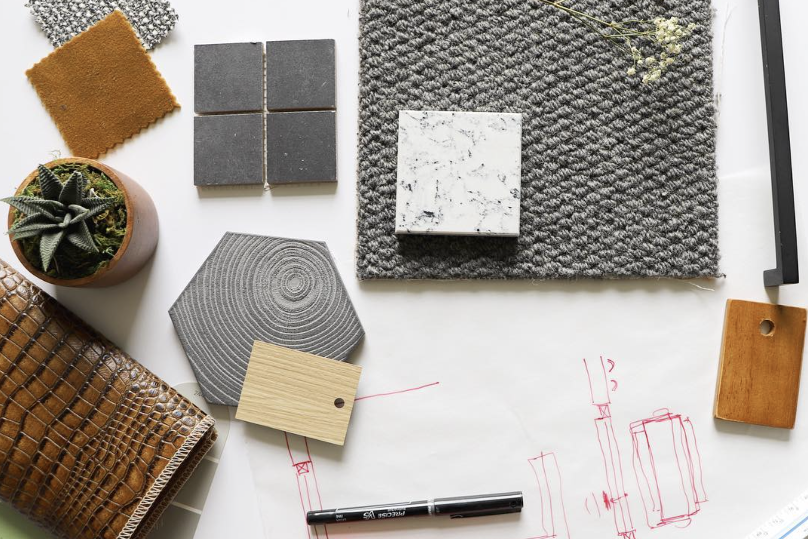 A variety of materials and tools for Twin Cities Furniture + Styling are laid out on a table.