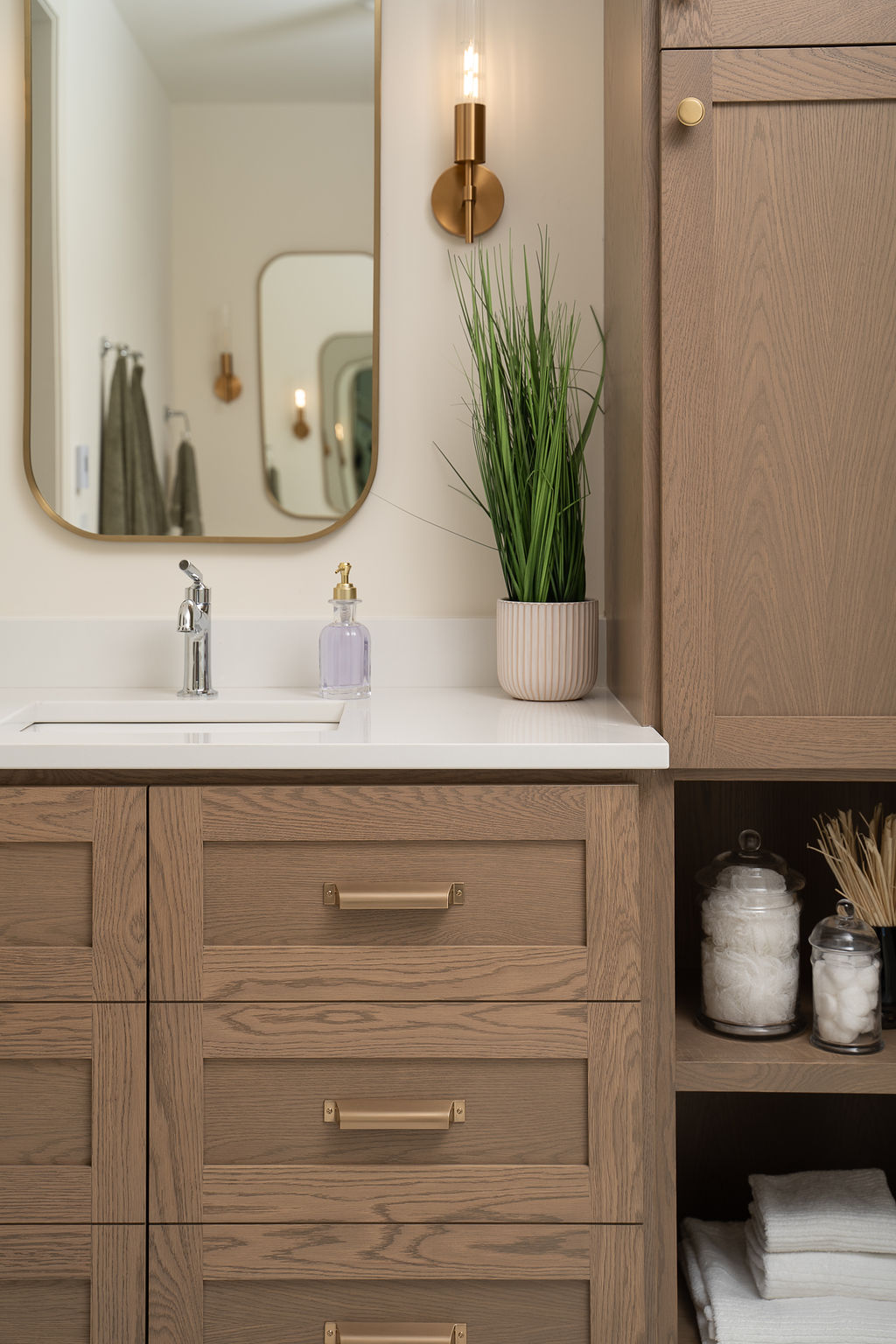 Master bathroom vanity with oak wood and gold hardware