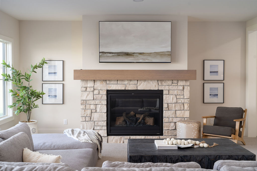 lower level living room with stone fireplace surround