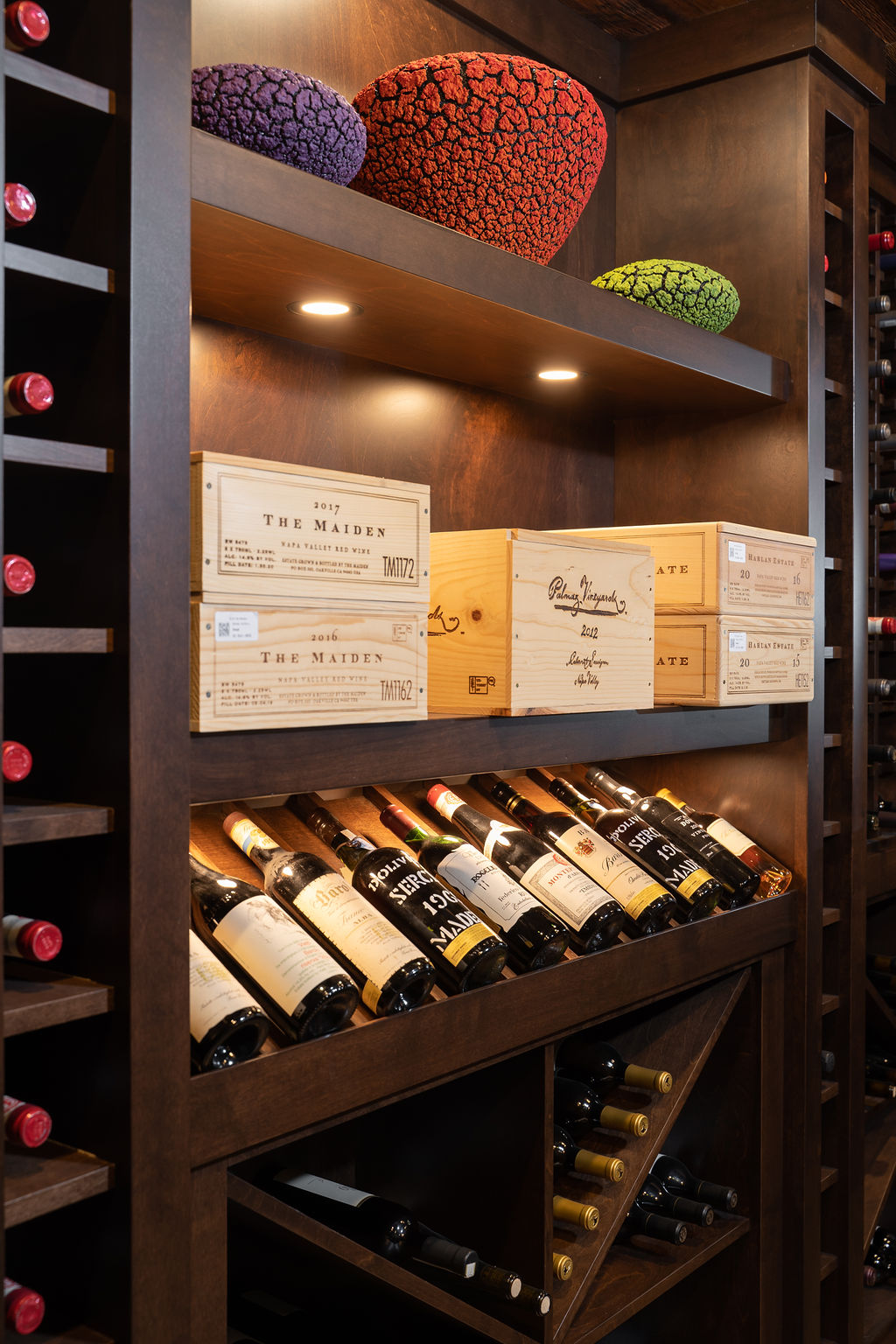 wine bottles lined up in wine cellar