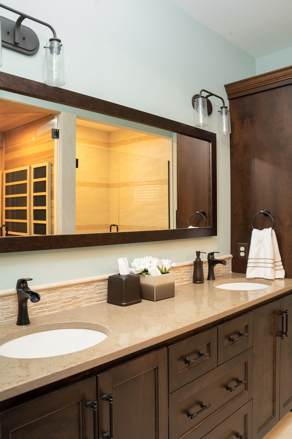 Bathroom with wooden double vanity and long mirror