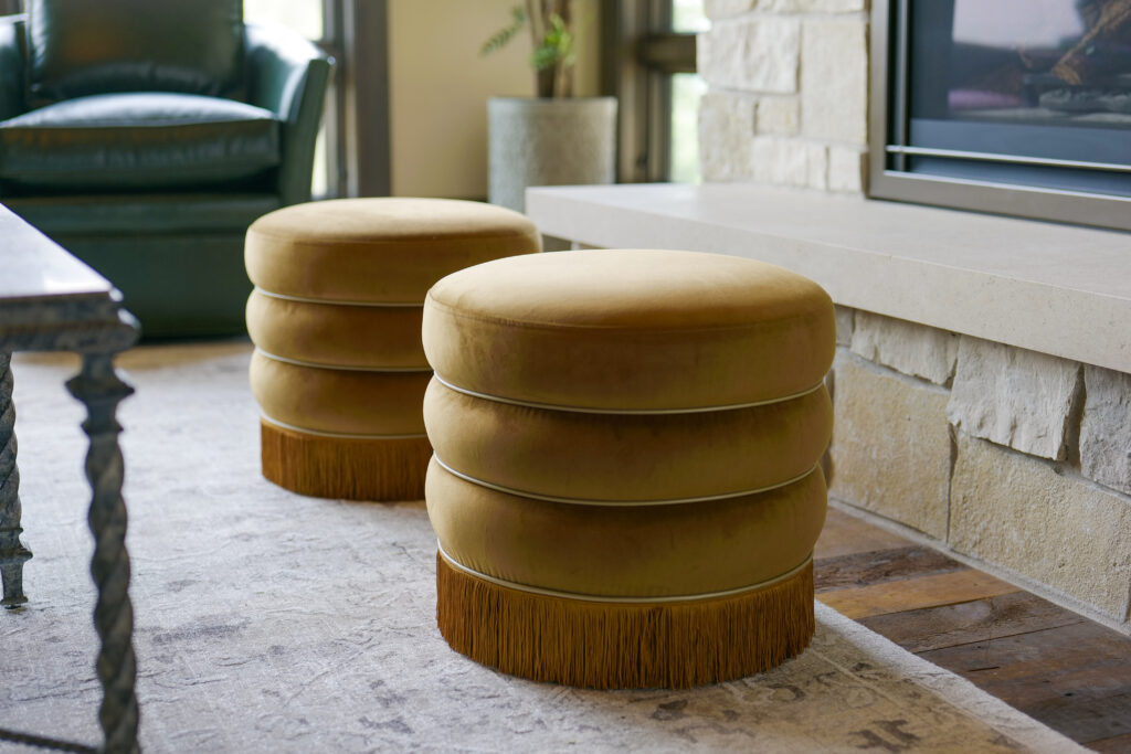 Two modern stools in front of a fireplace in a living room.