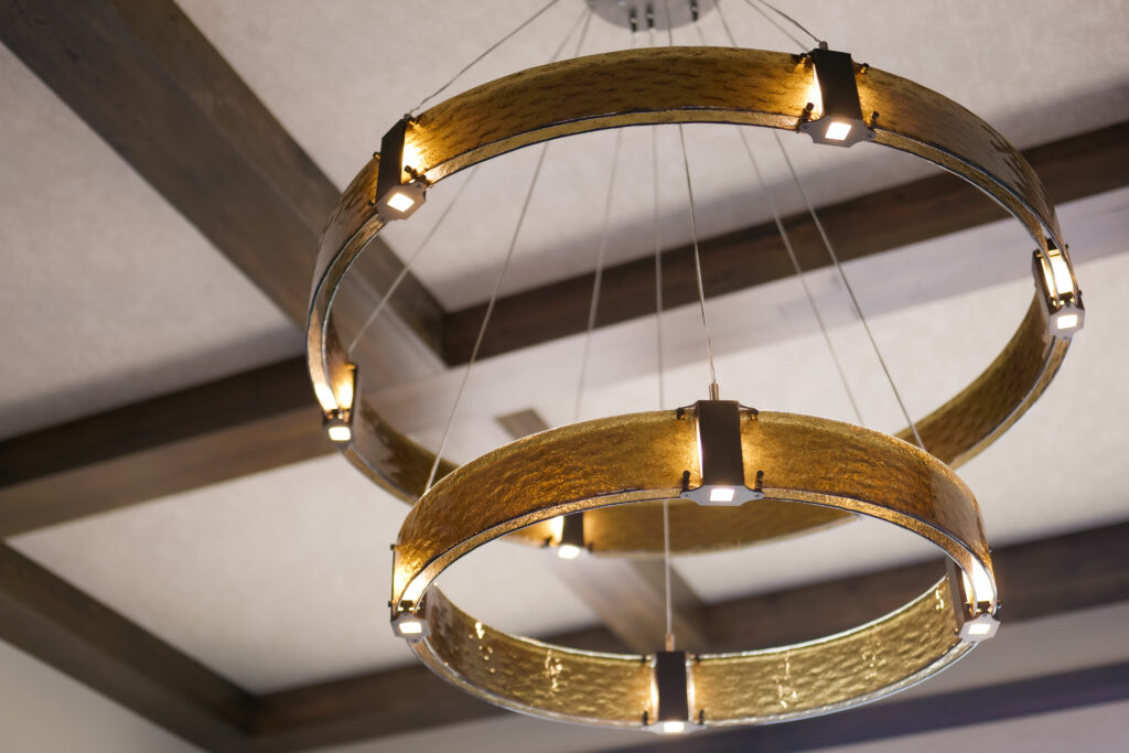 A modern chandelier with a circular shape hanging from the ceiling.