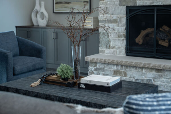 A living room with a fireplace and a coffee table, located on Woodside Road in Minnetonka.