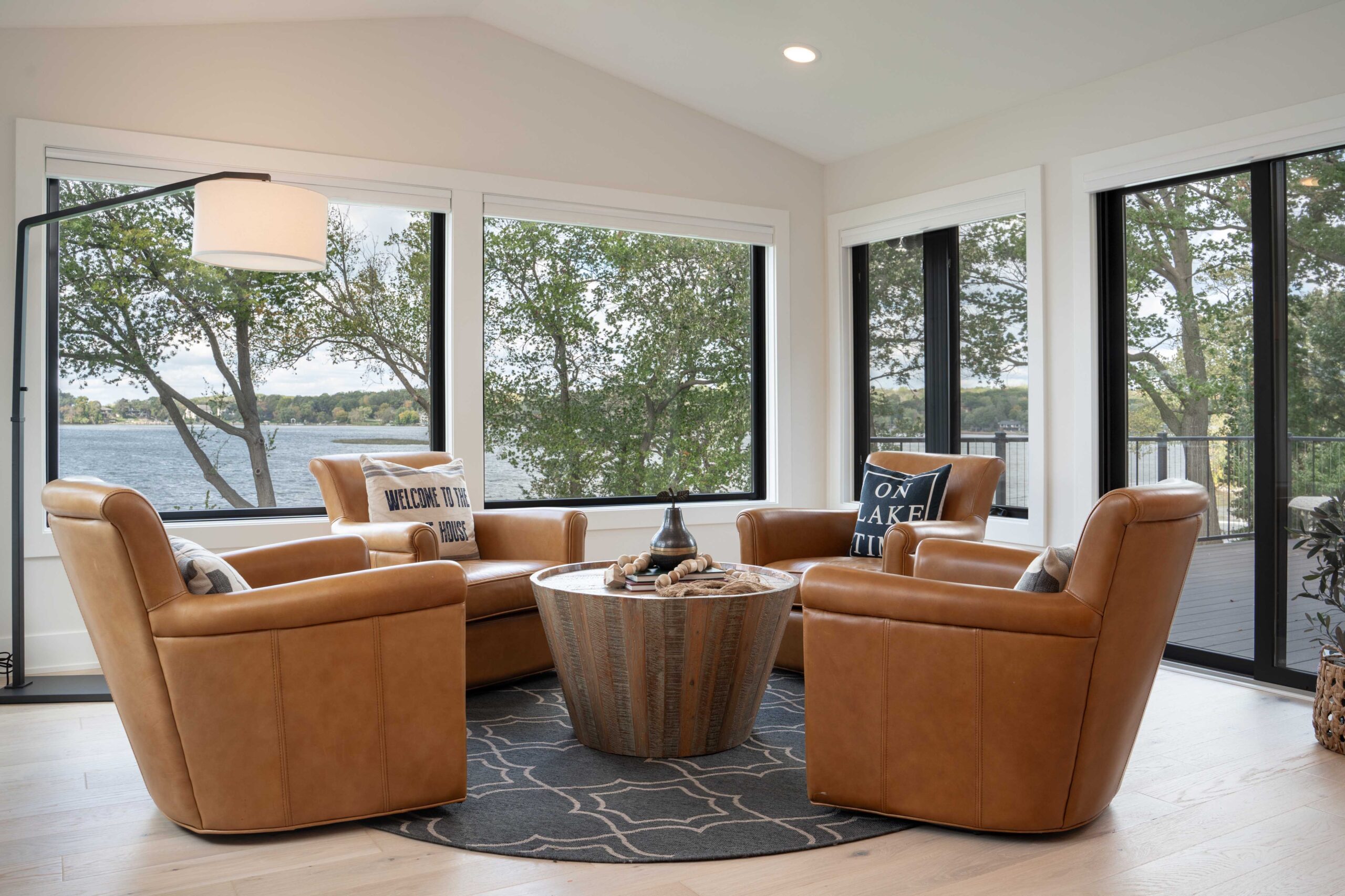An Orchard Lake remodel with large windows and leather chairs.