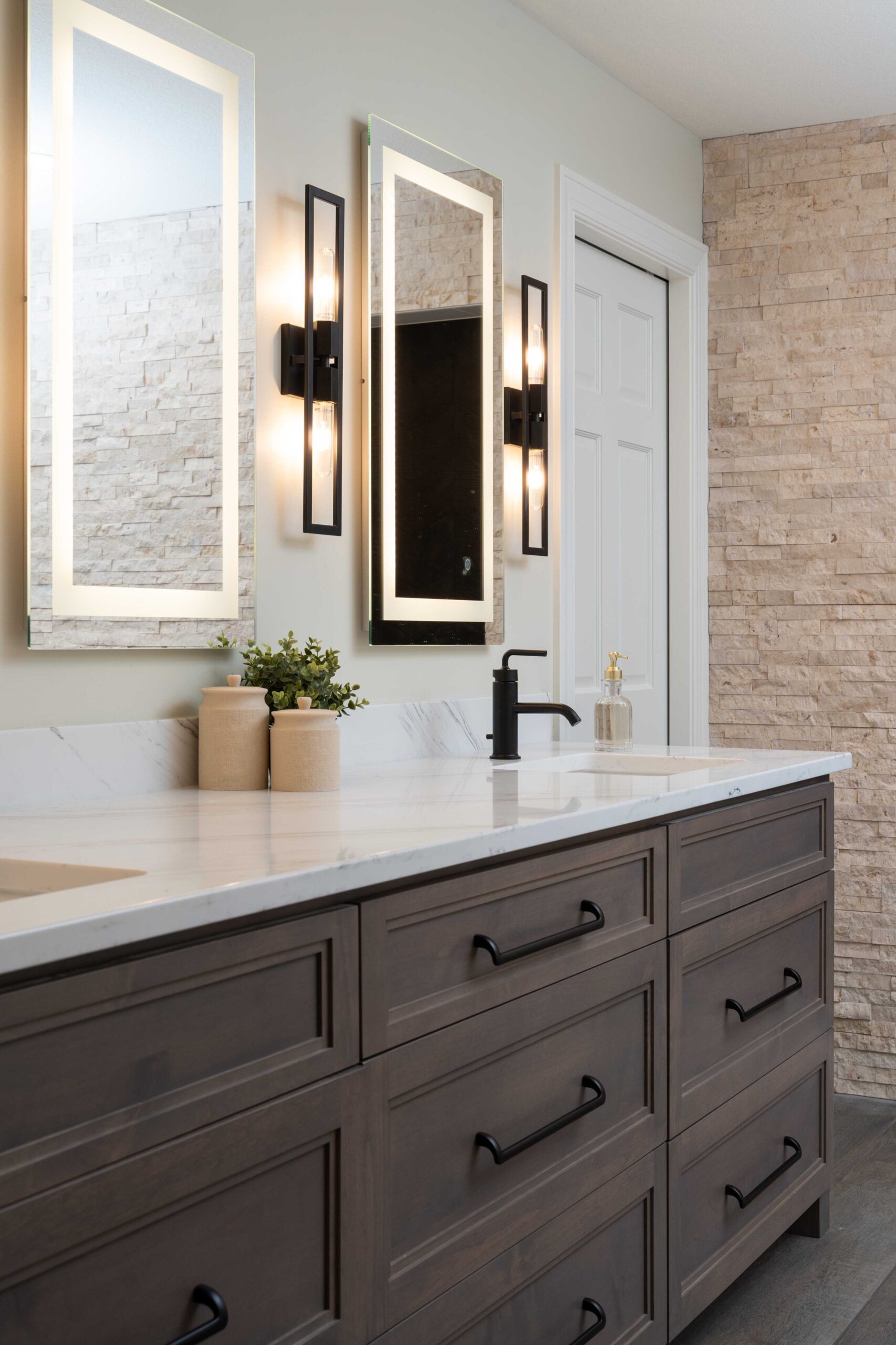 A bathroom with two sinks and two mirrors underwent a remodel on Woodside Road in Minnetonka.