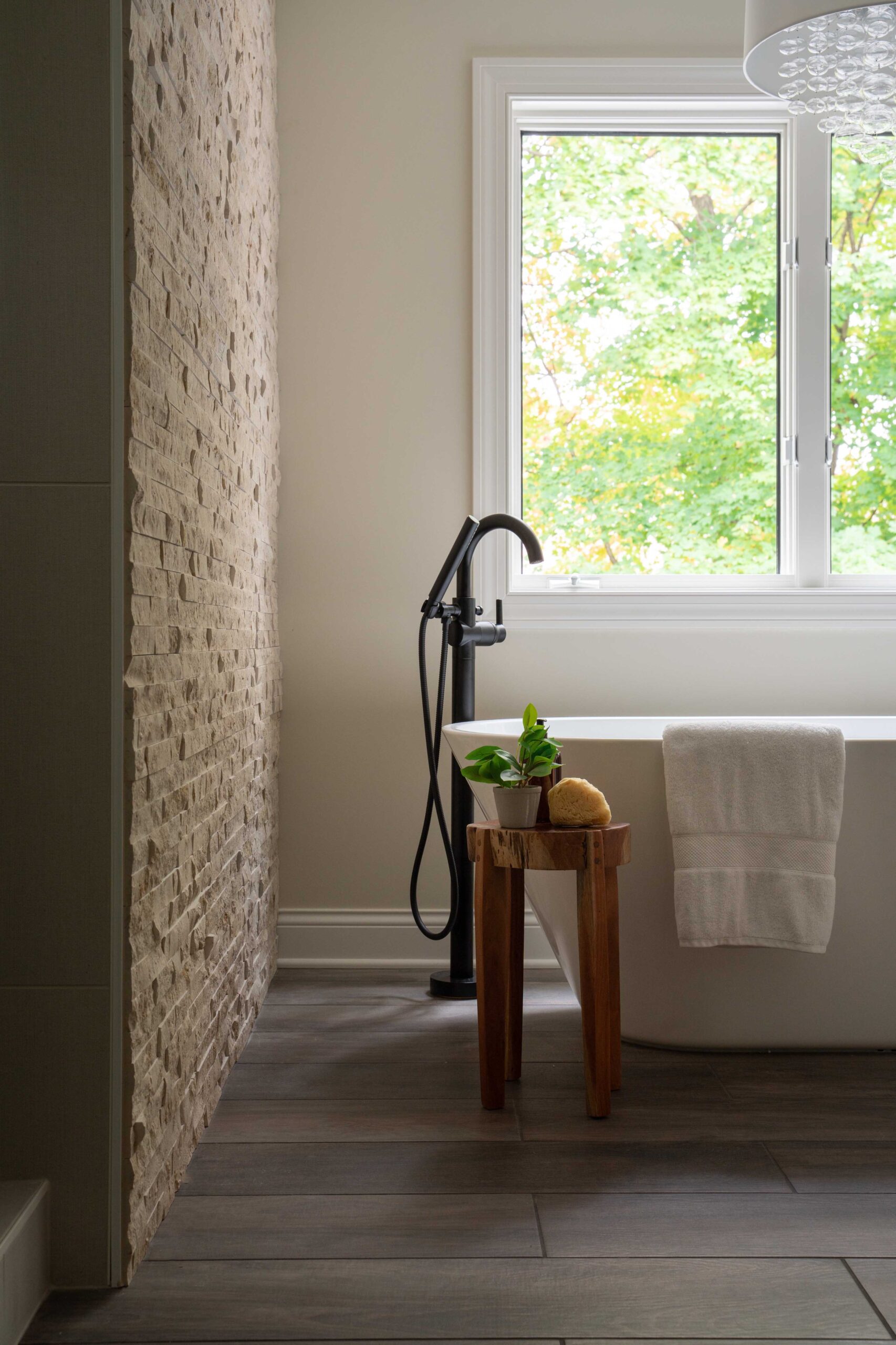 A bathroom with a wooden floor and a window located in Minnetonka, underwent a remodel on Woodside Road.
