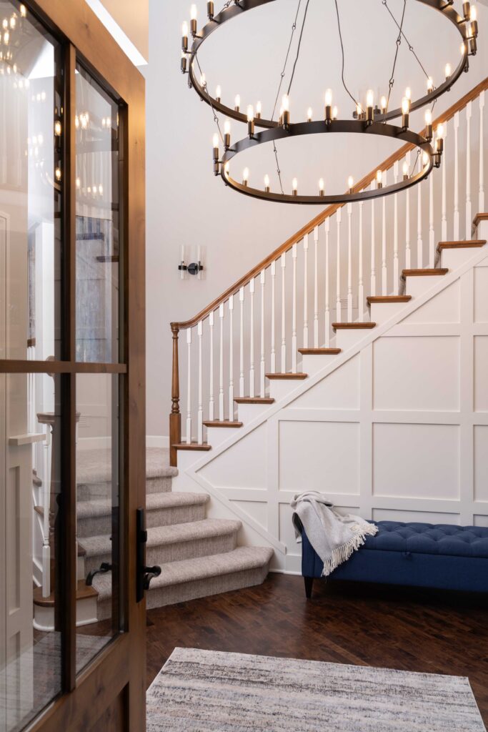 A chandelier hangs over the stairs in a remodelled home.