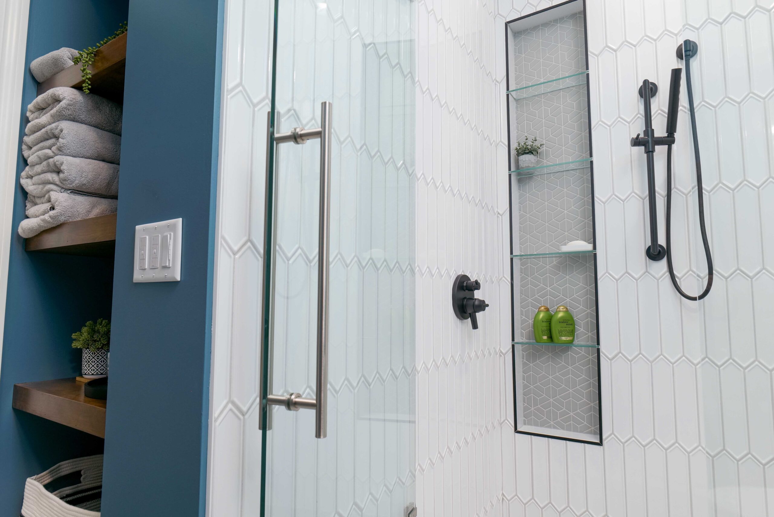 An Orchard Lake remodel featuring a blue and white bathroom with a glass shower door.