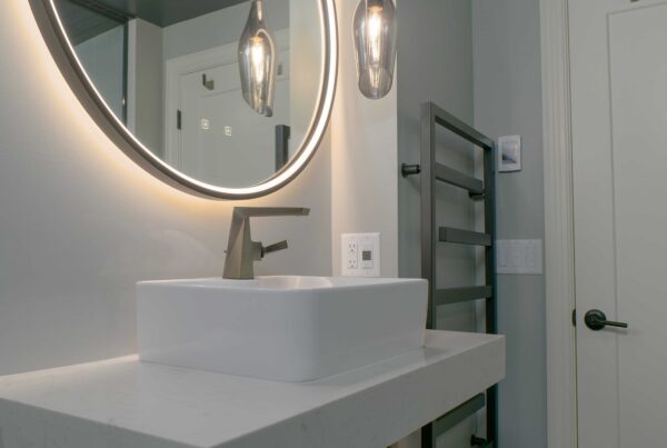 An Orchard Lake remodel featuring a bathroom with a sink and mirror.