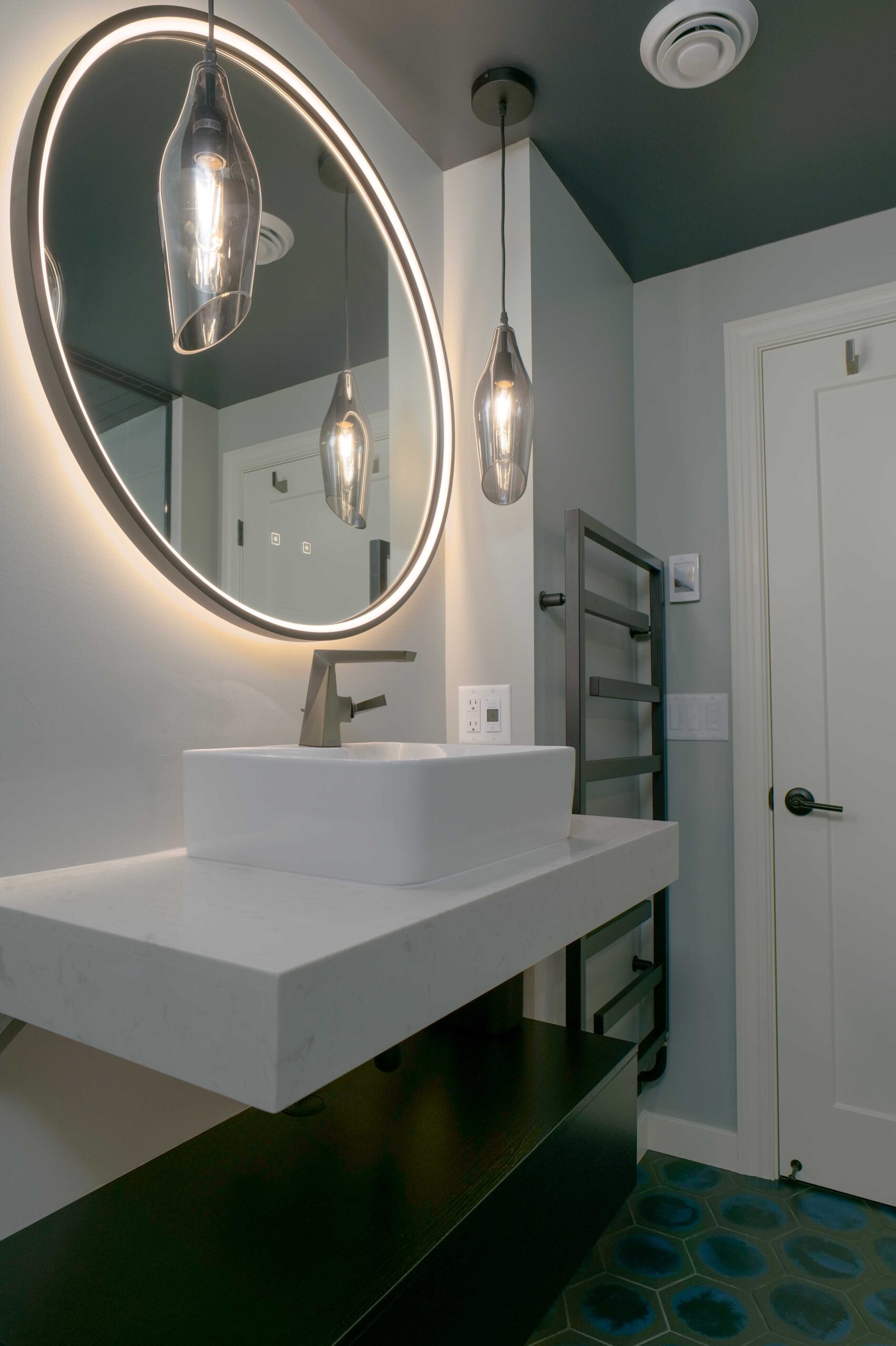 An Orchard Lake remodel featuring a bathroom with a sink and mirror.